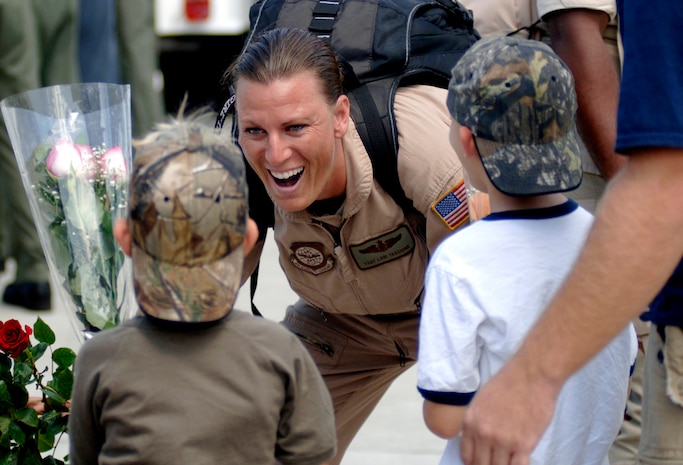 Tech. Sgt. Lorry Tascione, 16th Airlift Squadron loadmaster, greets her sons Vincent and Caleb with a smile on Charleston AFB Monday after a deployment to Southwest Asia. (U.S. Air Force Photo/Airman 1st Class Nicholas Pilch)(Released)