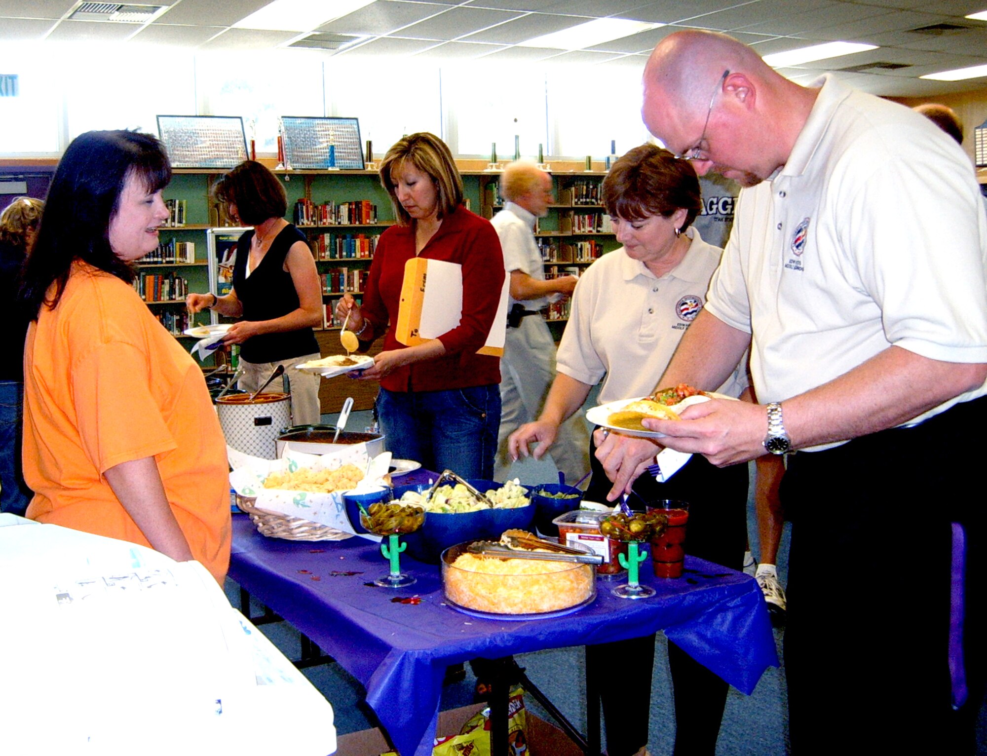 Parents and teachers help themselves to food during the PTA’s Teacher Staff Appreciation Luncheon at the DHS library. The luncheon is held at the end of every school year in honor of the staff who assist Edwards students with their education. (Courtesy photo)