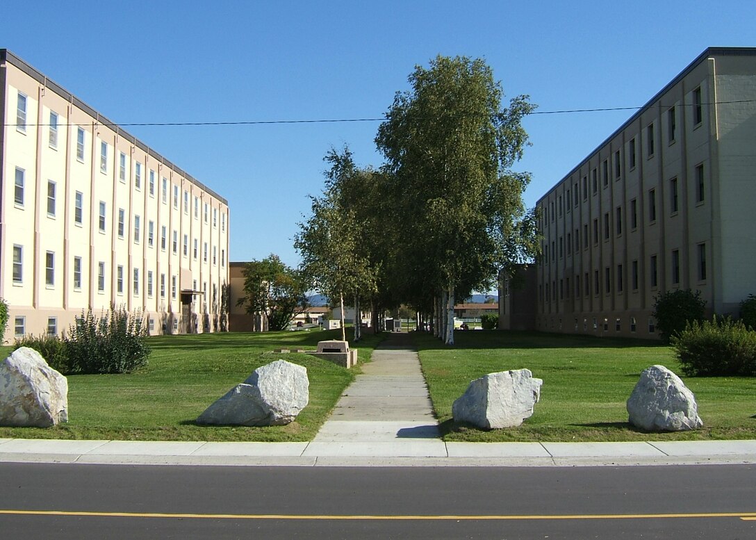 EIELSON AIR FORCE BASE, Alaska--Pictured, trees provide a canopy for a walkway between two of Eielson's dormitories. Our urban and native forests are actively managed to provide shade, wind breaks, color, fuel, visional and sound barriers for our community. Our trees provide shelter and food to wildlife; create a protective erosion belt around our surface waters; and improve the air quality. The natural resources office is recruiting volunteers to help plant trees and shrubs around base. For more information, call Mr. Tom Slater or Mr. Brent Koenen at 377-5182. (U.S. Air Force photo by Glyn Gardner)
