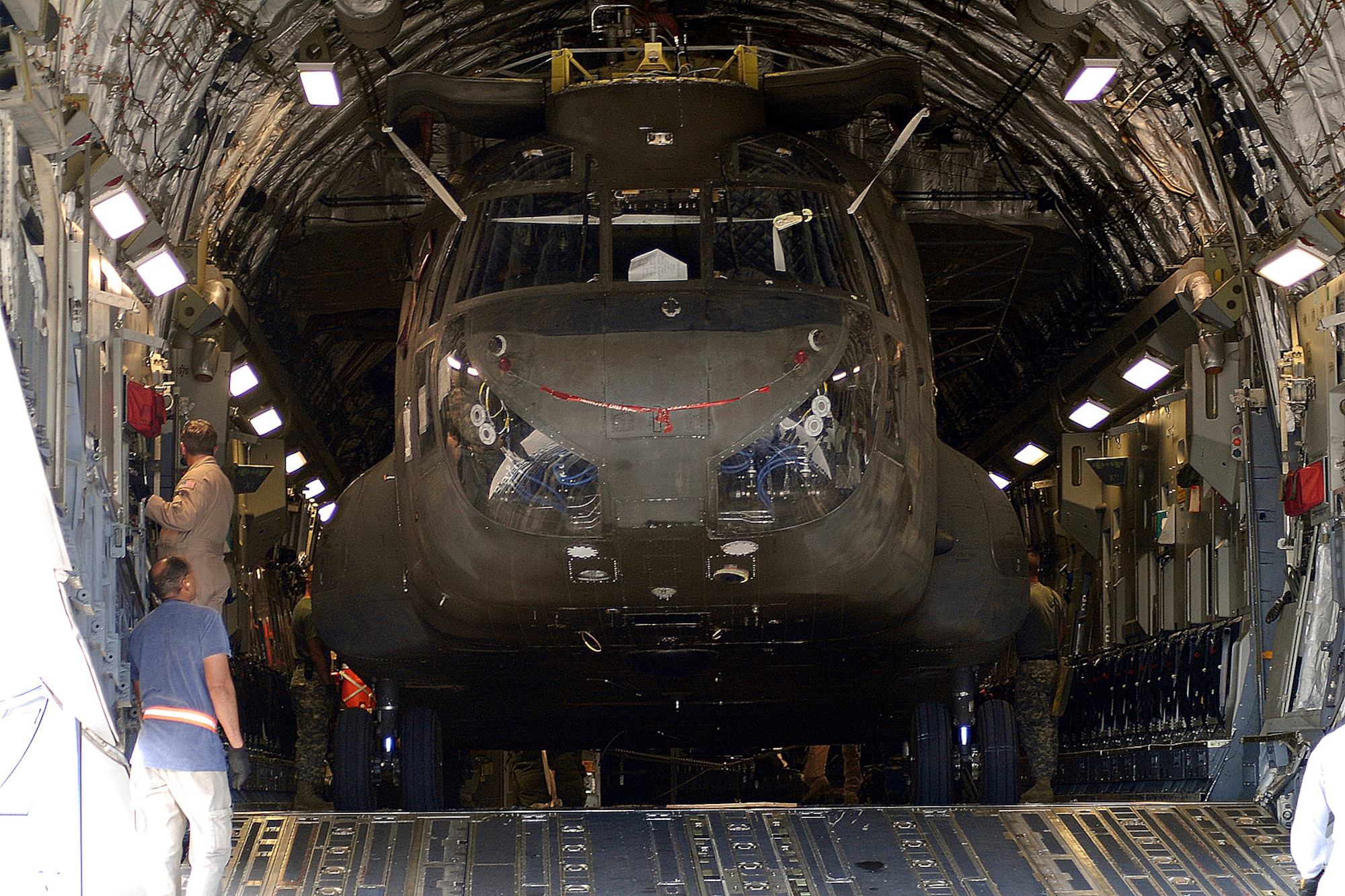 A Chinook CH-47D awaiting overseas deployment fills the cargo bay of a C-17. Employees from Sikorsky Support Services Inc. along with personnel from Company B, 3rd Battalion, 126th General Support Aviation Battalion, a National Guard unit from New York and Maryland, loaded the helicopter into the aircraft Aug. 30. (U.S. Air Force photo by Rob Bussard)