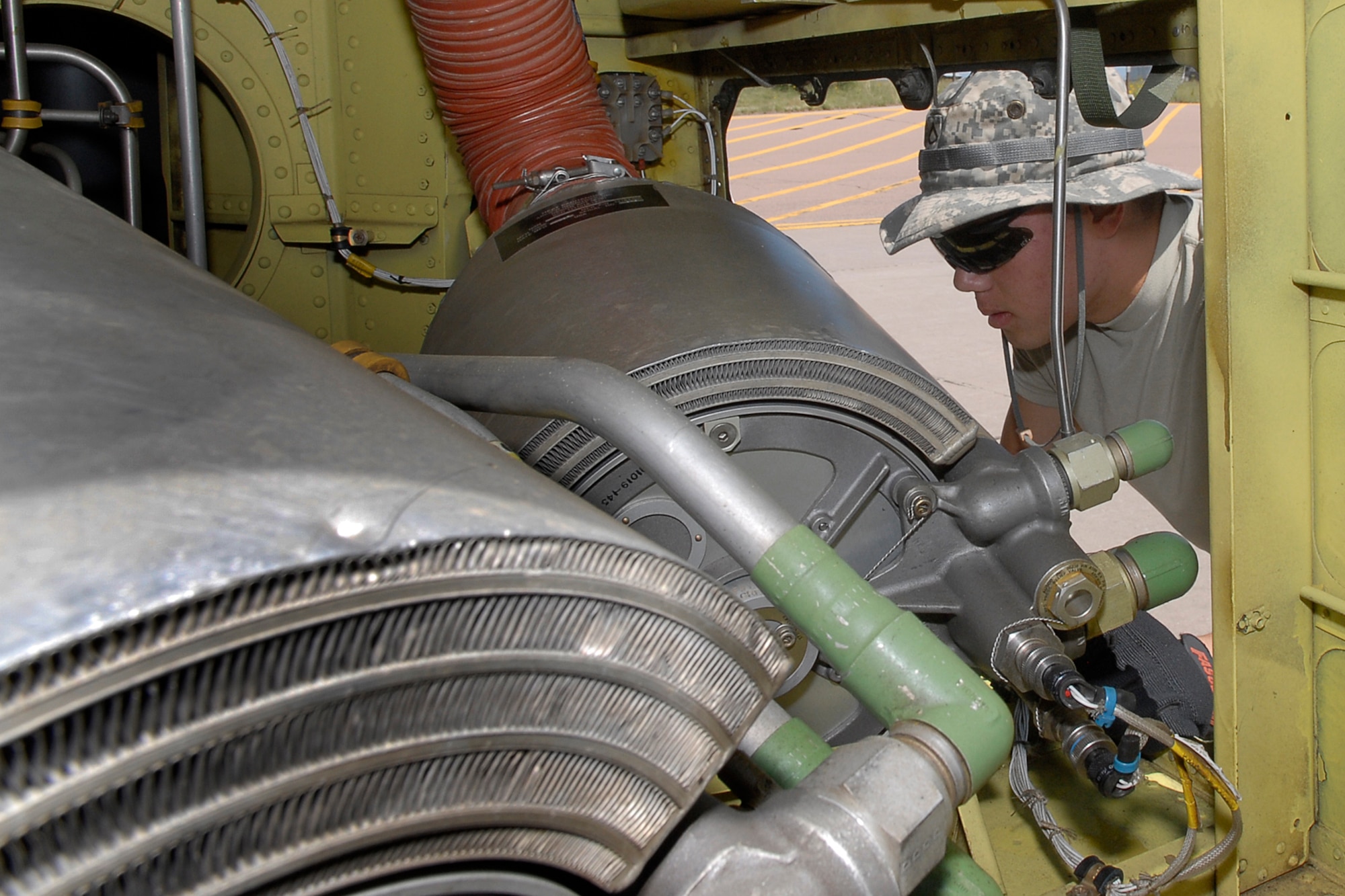 Pfc. Christopher Piwinski, Company B, 3rd Battalion, 126th General Support Aviation Battalion, evaluates a CH-47 rear rotor section during disassembly Aug. 16. (U.S. Air Force photo by Rob Bussard)