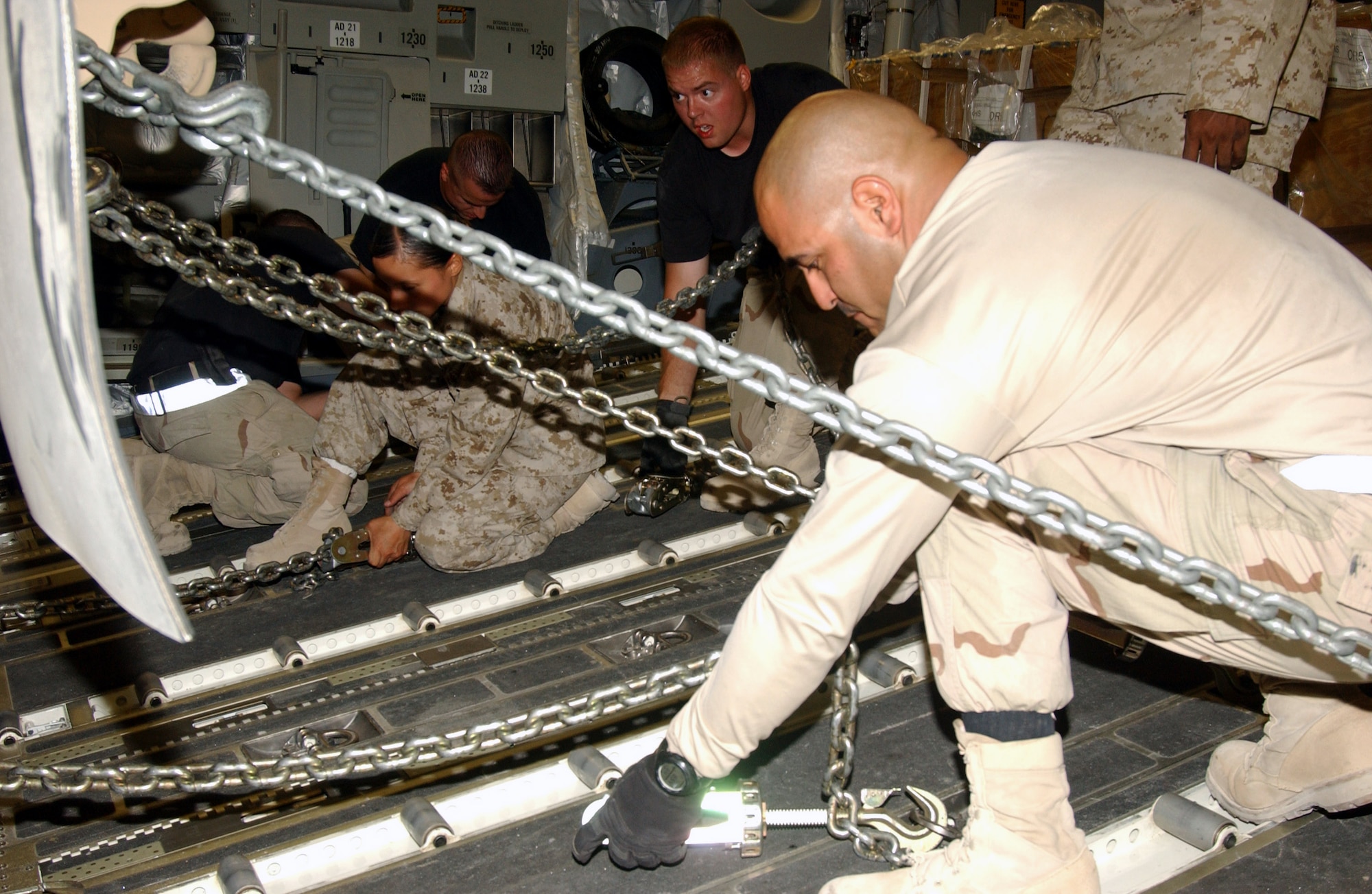 Staff Sgt. Edgar Perez and other aerial porters team up with Marines to strap a Mine Resistance Ambush Protected vehicle into a C-17 Globemaster III Aug. 25 at Al Asad Air Base, Iraq. The new MRAP Category III Buffalo models, which cost between $600,000 and $1 million each, will phase out the High Mobility Multipurpose Wheeled Vehicles, also known as Humvees. MRAPs have bottoms raised more than 3 feet off the ground to increase servicemembers' mobility and enhance mission success throughout the areas of responsibility. Sergeant Perez is an aerial transportation specialist with 438th Aerial Port Flight deployed from Pope Air Force Base, N.C. (U.S. Air Force photo/Senior Airman Olufemi A. Owolabi) 
