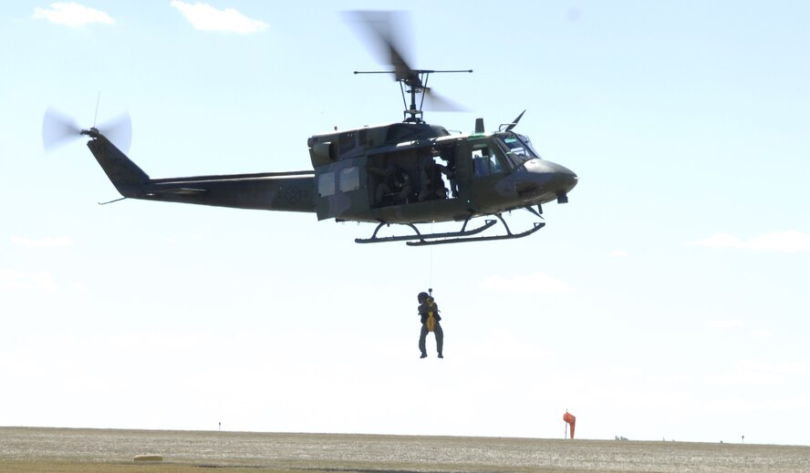 MINOT AIR FORCE BASE, N.D. -- The 54th Helicopter Squadron recently improved its search and rescue capabilities by outfitting two UH-1N helicopters with new rescue hoists. During a live test Aug. 29, Airman 1st Class Tim Merlin, 54 HS flight engineer, was hoisted into a helicopter. (U.S. Air Force photo by Senior Airman Christopher Boitz)