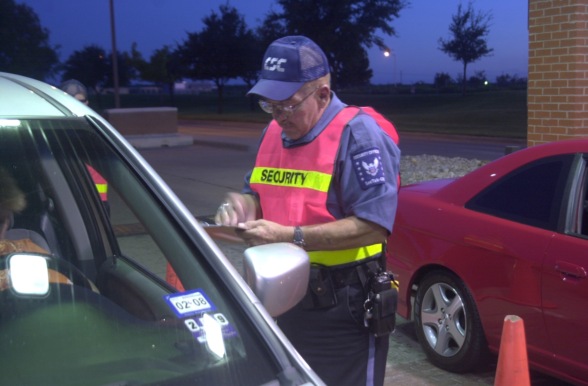 Computer Sciences Corporation security employee Ralph Craig conducts a random insurance measure at the Jacobson Gate Aug. 23. (U.S. Air Force photo by Airman 1st Class Stephen Musal)