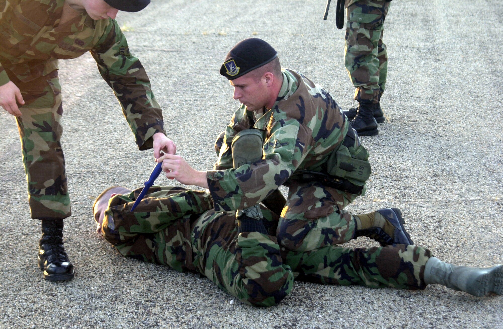 Airman Steven Goddard, a member of the 17th Security Forces Squadron, searches Tech. Sgt. Billy Banks during an exercise Aug. 23. Sergeant Banks simulated an armed gate runner who was apprehended by the 17 SFS. (U.S. Air Force photo by Airman 1st Class Stephen Musal)