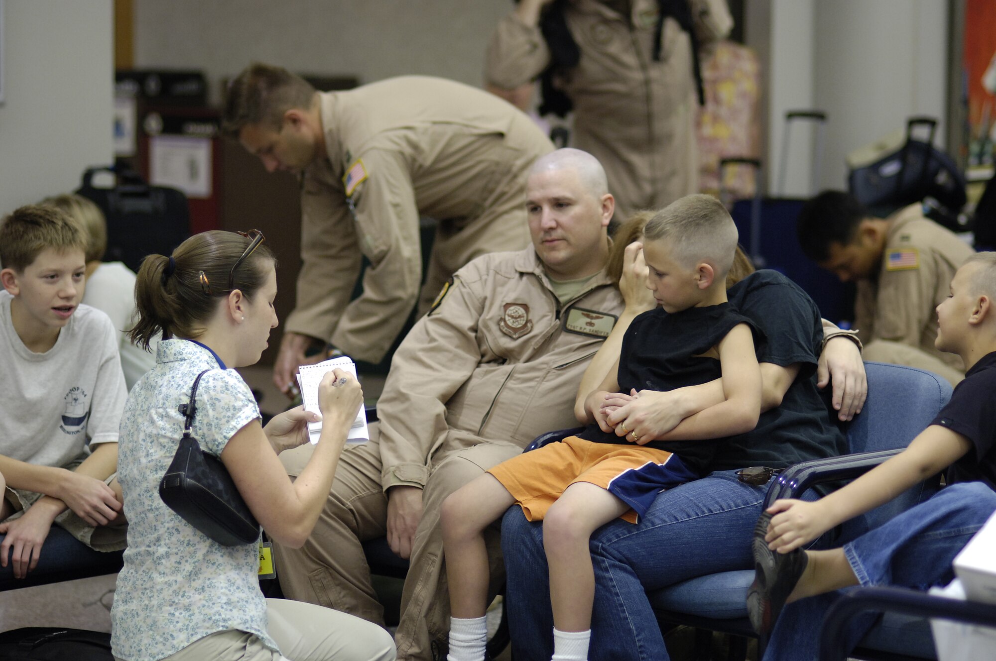 Tech. Sgt. Ronnie Sandifer, a loadmaster with the 6th Airlift Squadron, McGuire Air Force Base, N.J., and his family are interviewed by a member of the media while he waits at the passenger terminal here to deploy to Southeast Asia with his squadron in support of the Global War on Terrorism. Sergeant Sandifer is part of the Air Force's first single-squadron C-17 deployment. Along with members from other McGuire organizations, they will comprise the 816th Expeditionary Airlift Squadron. (U.S. Air Force photo/Kenn Mann)