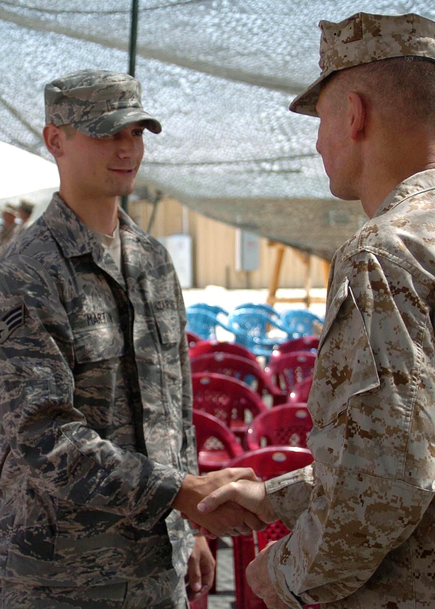 BAGRAM AIRFIELD, Afghanistan -- Airmen, along with other coalition services, shake hands with Chairman of the Joint Chiefs of Staff, Marine Gen. Peter Pace, in Ghazni, Afghanistan, September 2, during his final visit to the Operation Enduring Freedom area of operation before his retirement later this month. Gen. Pace individually thanked each Coalition forces member that he encountered on his visit, distributed coins to each one and answered questions during a question-answer session at each one of his stops in southern Afghanistan. (U.S. Air Force photo by Senior Airman Dilia DeGrego)