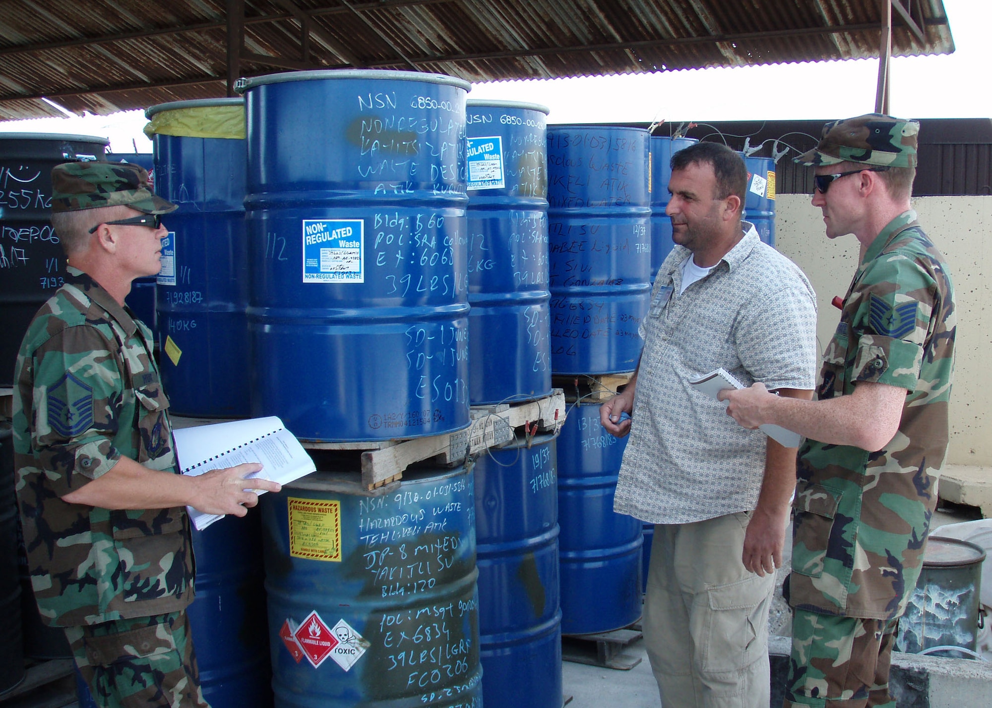 Master Sgt. Robert Hunt, 39th Logistics Readiness Squadron, fuels compliance environmental superintendant and Tech. Sgt. Patrick R Hyde, 39th Air Base Wing public affairs, interview Atilla Aglagu 39th Civil Engineer Squadron environmental technician on Incirlik's hazardous waste accumulation site for the internal ESOHCAMP evaluation Aug. 24. (U.S. Air Force photo by Tech Sgt Patrick R. Hyde)  