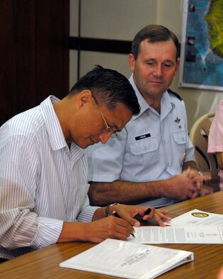 ADELUP, Guam - Guam's Lt. Gov. Michael Cruz, M.D., signs Proclamation No. 2007-081, naming Sept. 4 to 9, 2007, as Air Force Week.  More than 20 Andersen Airmen attended the proclamation signing which was held at the Ricardo J. Bordallo Governor's Complex in Adelup, Guam, Sept. 4.  The signing marked the first day of Guam's Air Force Week.  (Photo by Airman 1st Class Daniel Owen/ 36th Wing Public Affairs)