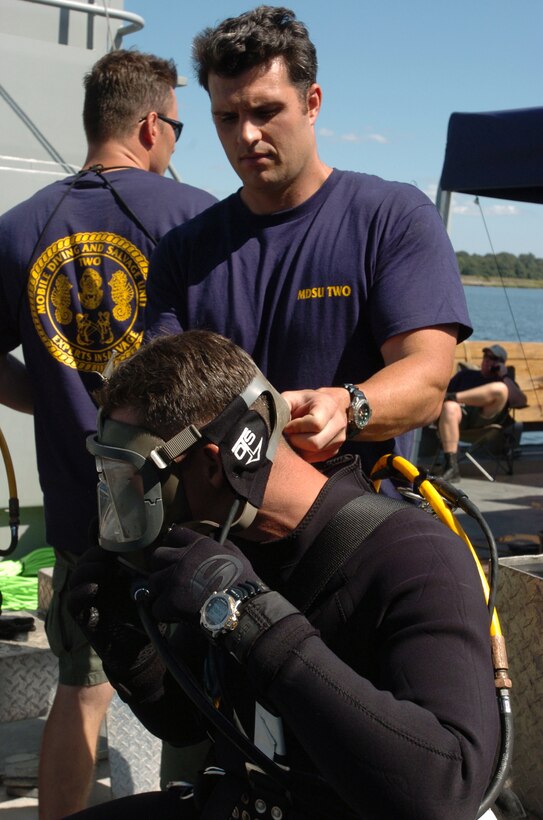 Navy diver Maximillian Yeager double-checks Army diver Sgt. Kristopher ...