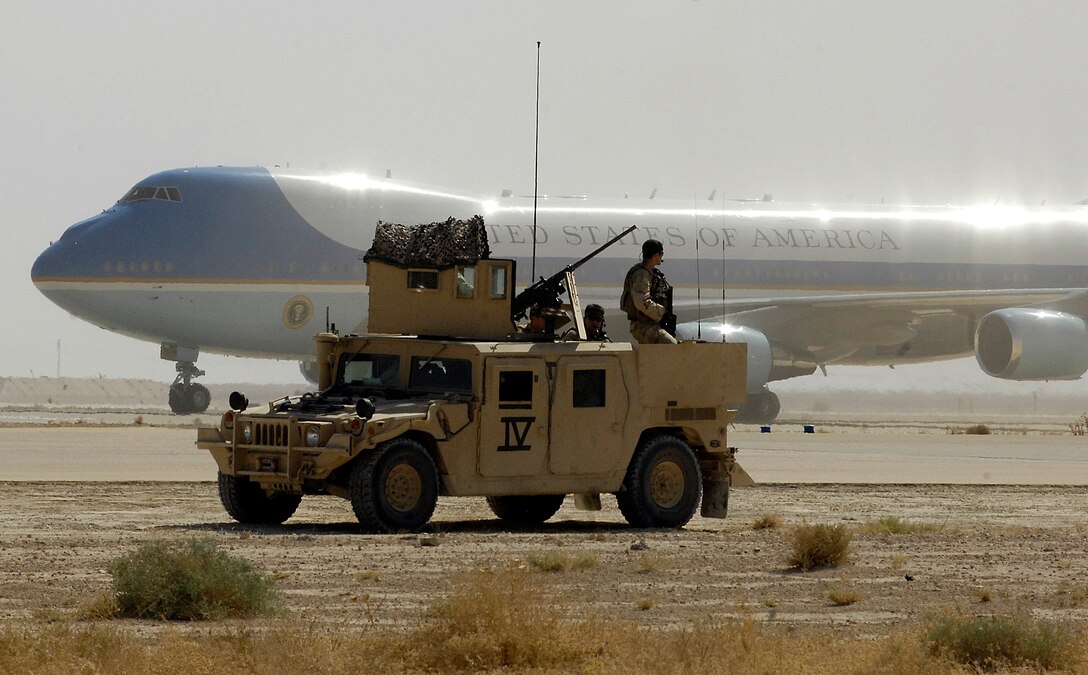 A U.S. Navy SEAL team helps secure the airfield as Air Force One lands at Al Asad Air Base, Iraq, Sept. 3, 2007.  President George W. Bush, Secretary of State Condolezza Rice, Secretary of Defense Robert M. Gates, Chairman of the Joint Chiefs of Staff Gen. Peter Pace, U.S. Central Command Commander Adm. William J. Fallon, Commander of Multinational Forces-Iraq Gen. David Petreaus, Commander of Multinational Corps-Iraq Lt. Gen. Ray Odierno, and others met at Al Asad to meet with Iraqi government leadership, sheiks from all over Anbar province and U.S. servicemembers deployed to Iraq.  