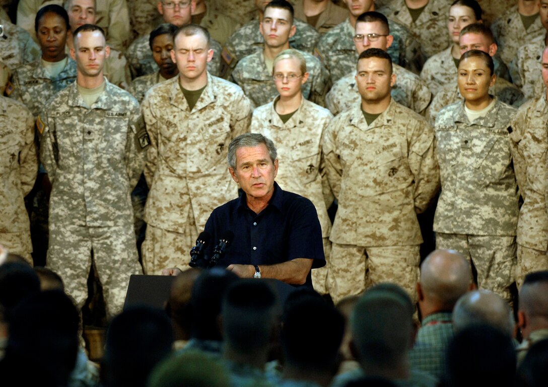 President George W. Bush speaks to U.S. servicemembers after meeting with top Iraqi government officials and sheiks from various regions in Al Anbar Provice at Al Asad Air Base, Iraq, Sept. 3, 2007.