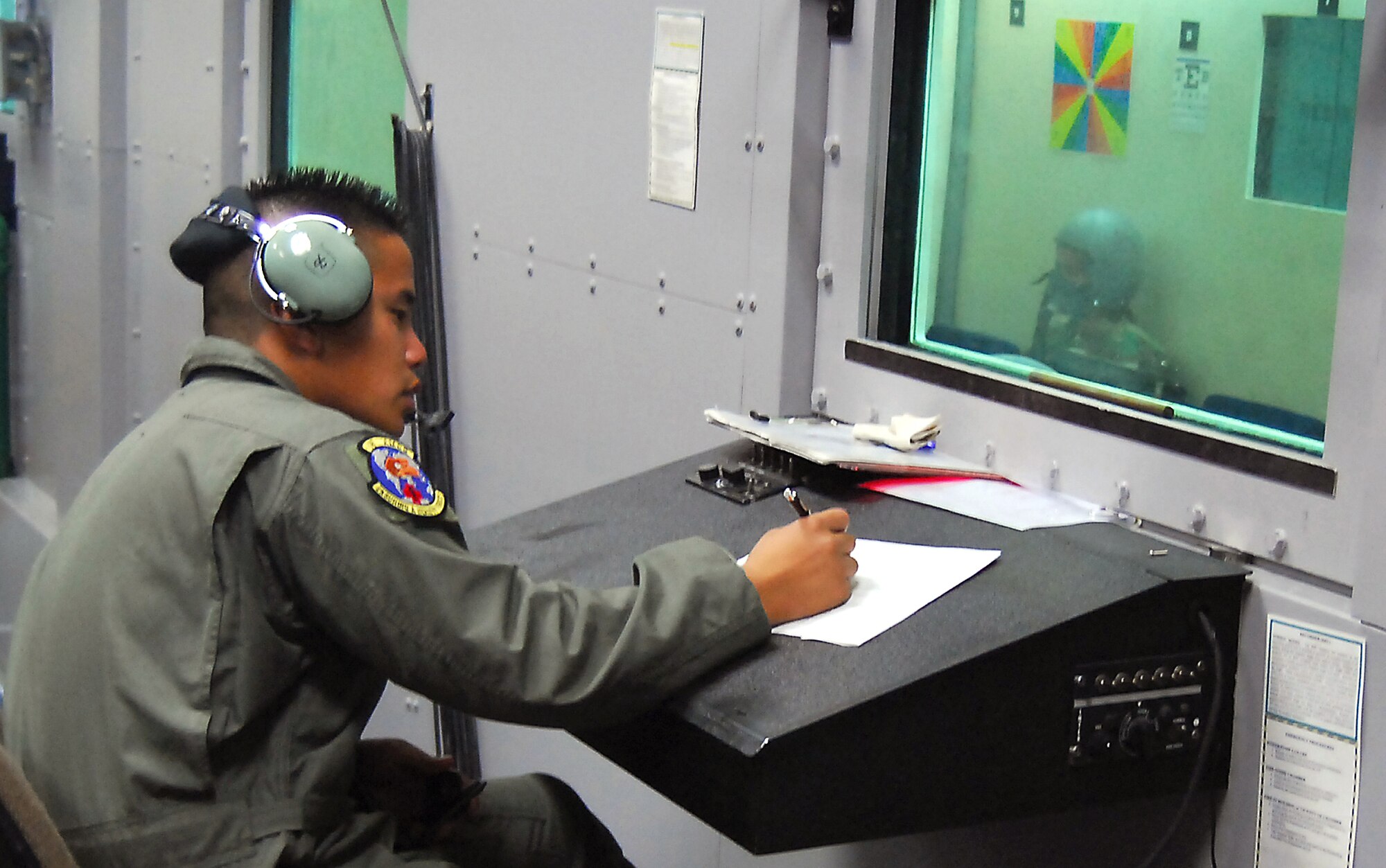 Airman 1st Class Reynato Ancheta documents everything that happens to a class  from the time that it takes to reach specific altitudes to what time each student displays symptoms of hypoxia for safety and historical reasons  Aug. 28, 2007, Kadena Air Base, Japan.  The mission of the altitude chamber is to teach military personnel who fly in aircraft, to identify, recognize and treat symptoms of hypoxia.  Airman Ancheta is an instructor for the Physiological Training Flight, 18th Aerospace Medicine Squadron.   U.S. Air Force photo/Airman 1st Class Kelly Timney