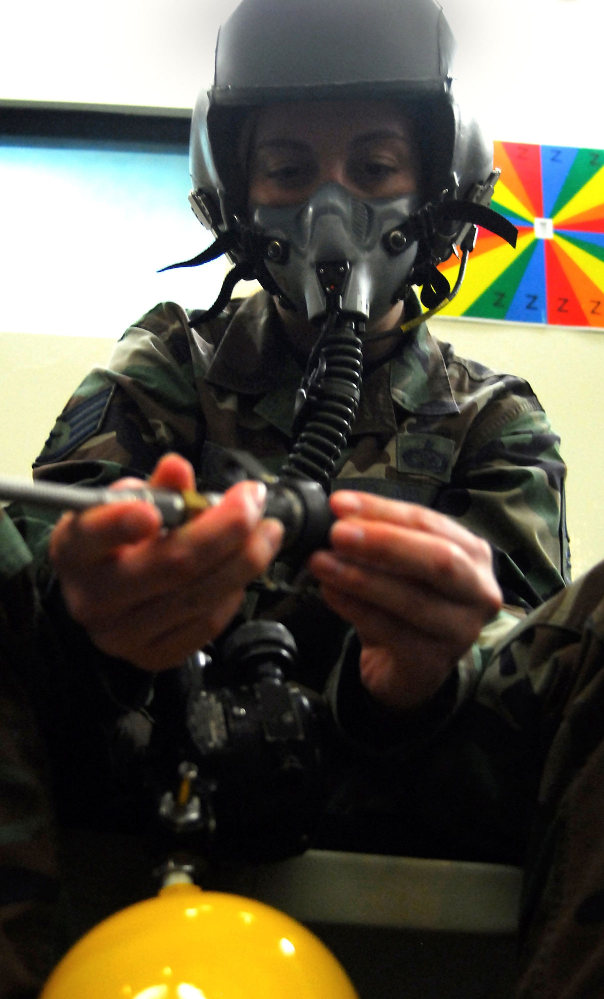 Staff Sgt. Chrissy FitzGerald connects into the oxygen supply during her altitude chamber class, Aug. 28, 2007, at Kadena Air Base, Japan.  The mission of the altitude chamber is to teach military personnel who fly in aircraft, to identify, recognize and treat symptoms of hypoxia. Sergeant FitzGerald is assigned to 18th Wing Public Affairs . U.S. Air Force photo/Airman 1st Class Kelly Timney