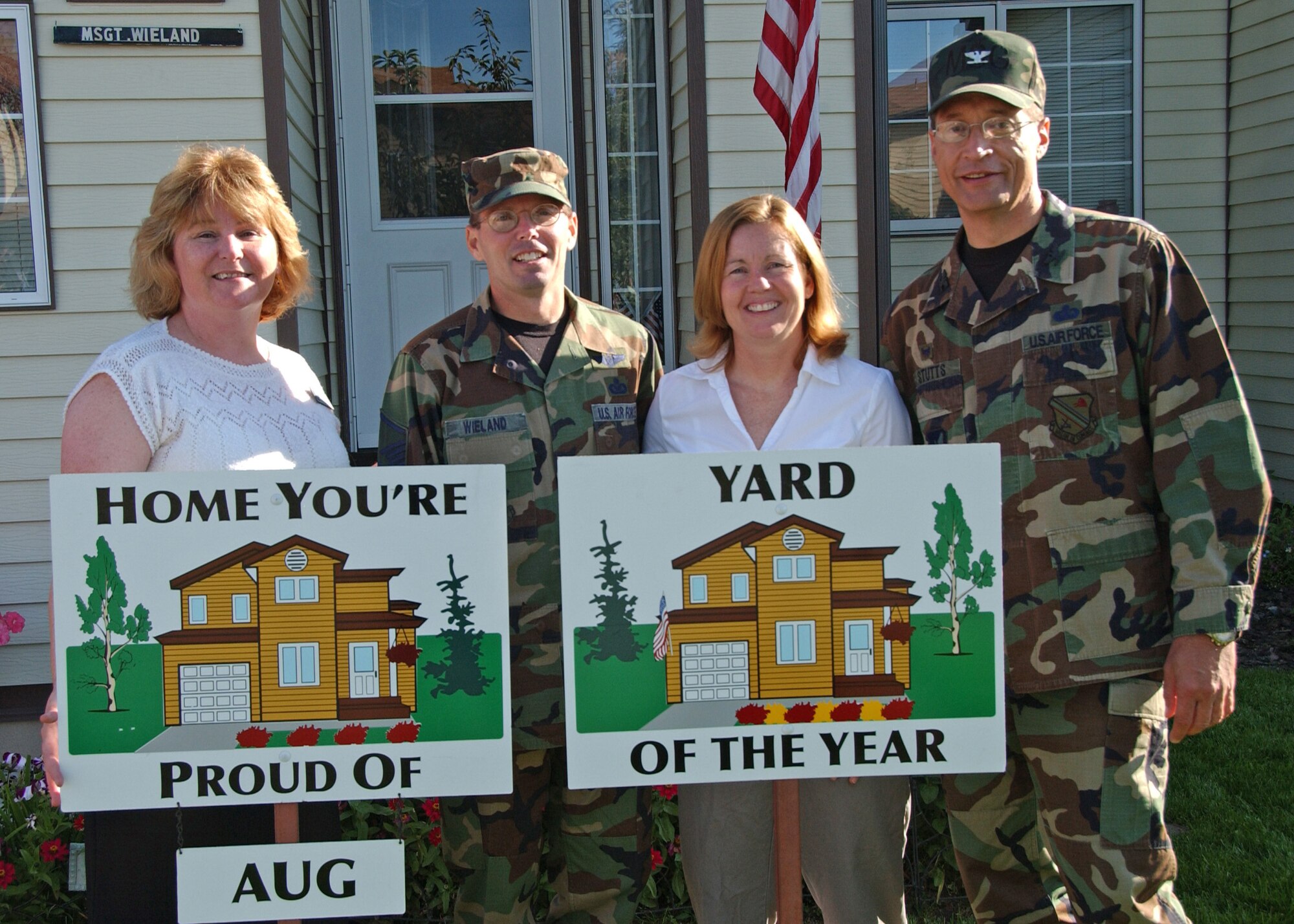EIELSON AIR FORCE BASE, Alaska--Master Sgt. Robert Wieland, 354th Fighter Wing Public Affairs, and spouse, Jenny, pose for a picture with Col. John Stutts, 354th Mission Support Group commander, and Lorie Dallas, 354th CES military family housing, Sept. 5 during the last Home You're Proud Of recognition for the summer. Sergeant Wieland and his family are the winners for Area 2 and are also the winners for 2007's Yard of the Year. Each household to win in their area received gift certificates amounting to $125 from agencies on and off base. HYPO is sponsored by the Eielson Enlisted and Officer's Spouses Club. (U.S. Air Force photo by Airman 1st Class Christopher Griffin)