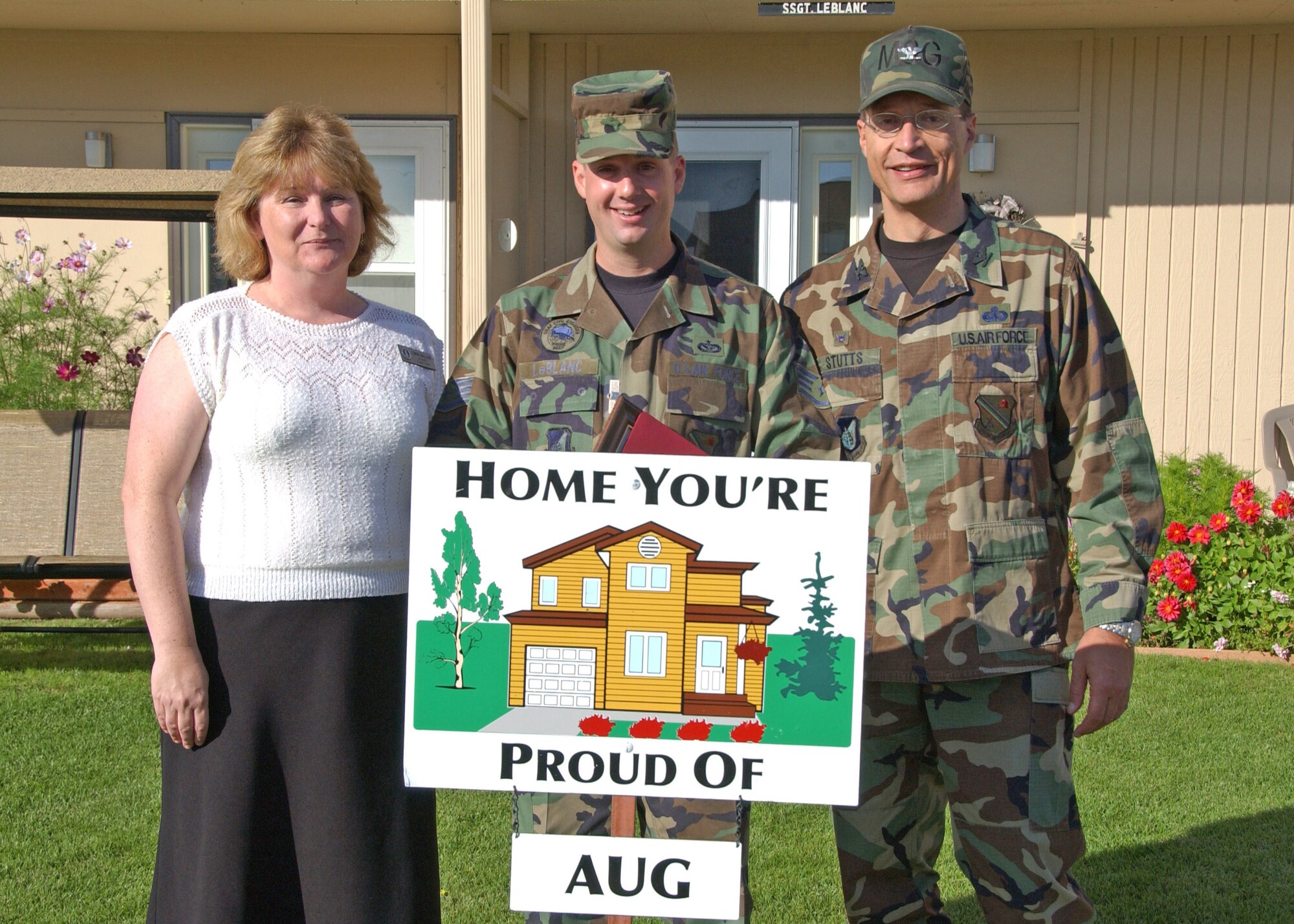 EIELSON AIR FORCE BASE, Alaska--Staff Sgt. Christopher LeBlanc, 354th Civil Engineer Squadron, poses for a picture with Col. John Stutts, 354th Mission Support Group commander, and Lorie Dallas, 354th CES military family housing, Sept. 5 during the last Home You're Proud Of recognition for the summer. Sergeant LeBlanc and his family are the winners for Area 1. Each household to win in their area received gift certificates amounting to $125 from agencies on and off base. (U.S. Air Force photo by Airman 1st Class Christopher Griffin)
