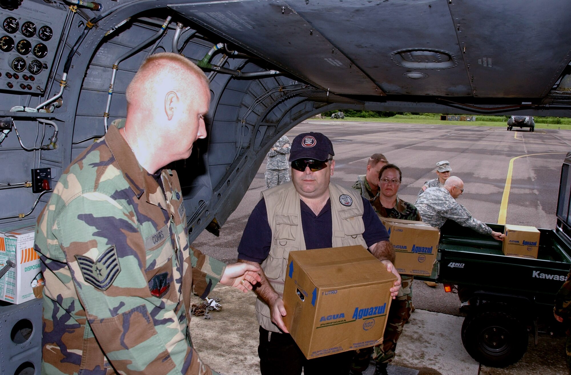 Tech. Sgt. Vernon Cohrs and Dana Chivers load supplies on a CH-47 Chinook in preparation for the deployment of a nine-member disaster assessment team to Nicaragua Sept. 5 at Soto Cano Air Base in Honduras. The team will provide damage assessment following Hurricane Felix which made landfall in Central America Sept. 4. Sergeant Cohrs is assigned to Joint Task Force-Bravo, and Mr. Chivers is an Office of U.S. Foreign Disaster Assistance adviser assigned to U.S. Southern Command. (U.S. Air Force photo/Martin Chahin) 
