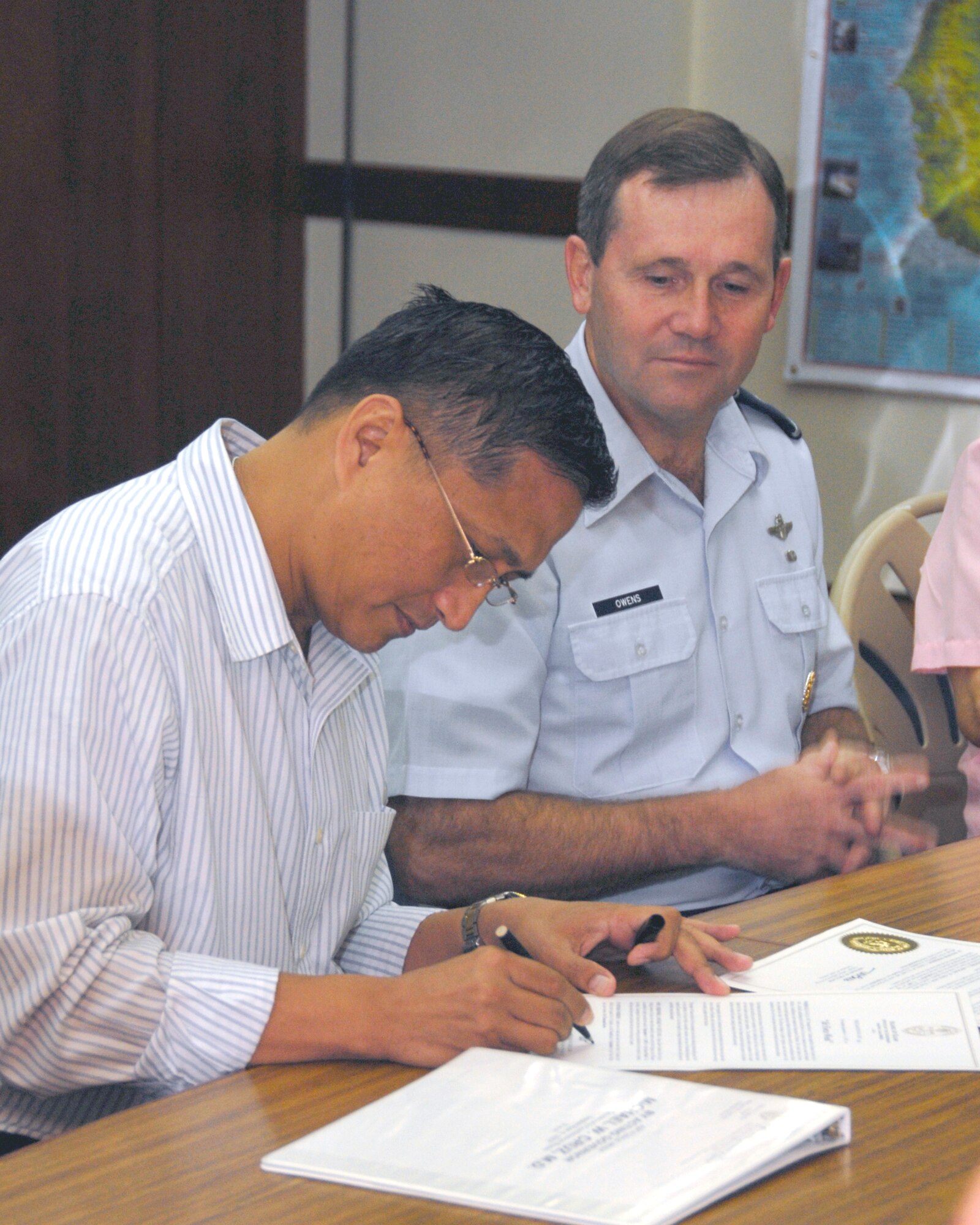 Guam's Lt. Gov. Michael Cruz signs Proclamation No. 2007-081, naming Sept. 4 to 9 as Air Force Week. More than 20 Andersen Airmen attended the proclamation signing which was held at the Ricardo J. Bordallo Governor's Complex in Adelup, Guam, Sept. 4. (U.S. Air Force photo/Airman 1st Class Daniel Owen) 