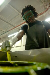 Airman 1st Class Shanae Brown, 437th Maintenance Squadron NDI apprentice,  inspects a torque tube from a C-17 using a fluorescent penetrate test Wednesday at the NDI lab on Charleston AFB. (U.S. Air Force photo/Airman 1st Class Nicholas Pilch) 
