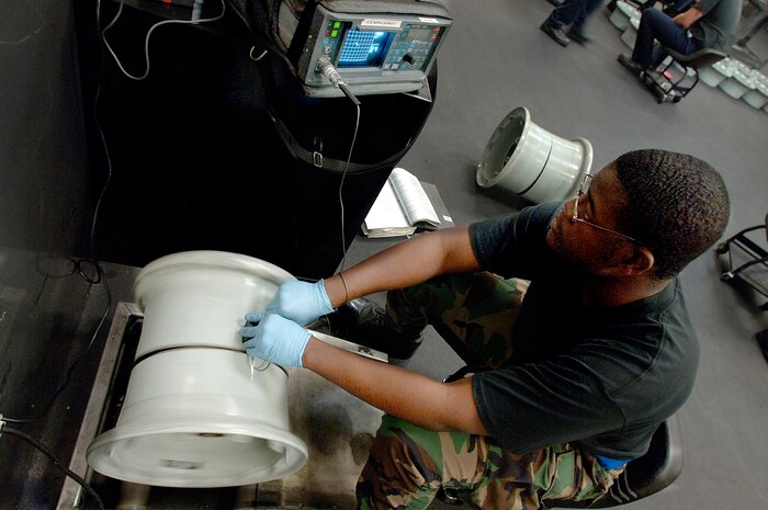Airman 1st Class DeMarcus Johns, 437th Maintenance Squadron NDI specialist, inspects the bead seed of a nose landing gear wheel from a C-17 with a 19-E eddy current machine Wednesday at the wheel and tire shop on Charleston AFB.   (U.S. Air Force photo/Airman 1st Class Nicholas Pilch) 