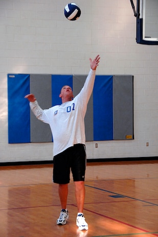 Ken Packwood, SFS, serves the ball to CES during the second game. (U.S. Air Force photo/Senior Airman Sam Hymas)