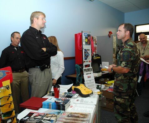 Glenn Bliss from General Distributing talks to Master Sgt. Sean O'Connell, 120th Fighter Wing, about his company at the Government Purchase Card event at the chapel Sept. 5. The event was held for local vendors to get familiar with the base and expose base members to the services they provide