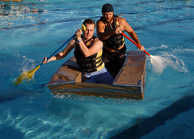 Senior Airman Travis Edwards, 99th Air Base Wing Public Affairs, and Charles Keebaugh row their way to victory in the third annual Build-a-Boat race at the base swimming pool Aug. 29. The Public Affairs team won $100 prize money and bragging rights for the year.