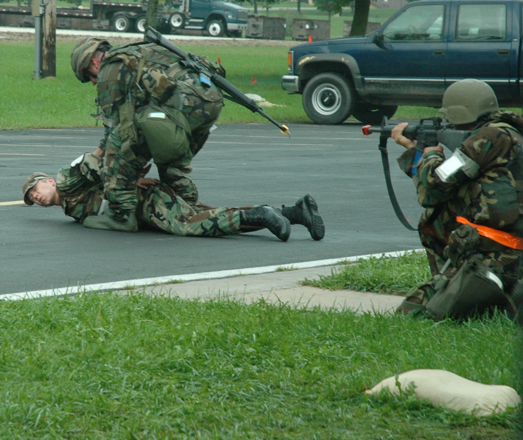 A member of the 802nd Air Expeditionary Wing security forces searches and interrogates a prisoner under the armed, and watchful eye of a team member. The  Citizen Warriors of the 940th Air Refueling Wing, Beale Air Force Base, Calif., teamed up with the 445th Air Mobility Wing, Wright Patterson AFB, Ohio and the 452nd AMW, March Air Reserve Base, Calif., for an Operational Readiness Exercise at the Combat Readiness Training Center, Volk Field, Wis. The three wings became the 802nd AEW for this exercise that tested the Reservists ability to operate and survive in a deployed location. More than 425 Air Force Reservists teamed up for this exercise, and will come together again in October at the Gulfport, Miss., CRTC. (US Air Force photo/Master Sgt Ellen L Hatfield).