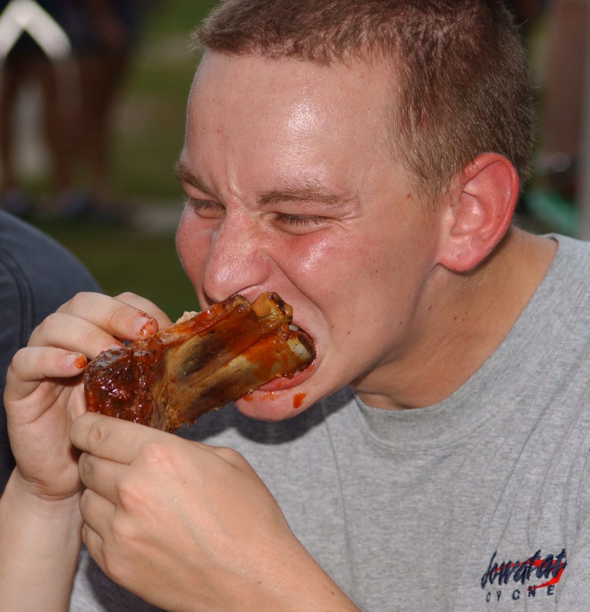 Staff Sgt. Vincent Struglinski, 338th TRS, devours the free barbecue ribs provided at the picnic.  (U.S. Air Force photo by Kemberly Groue)