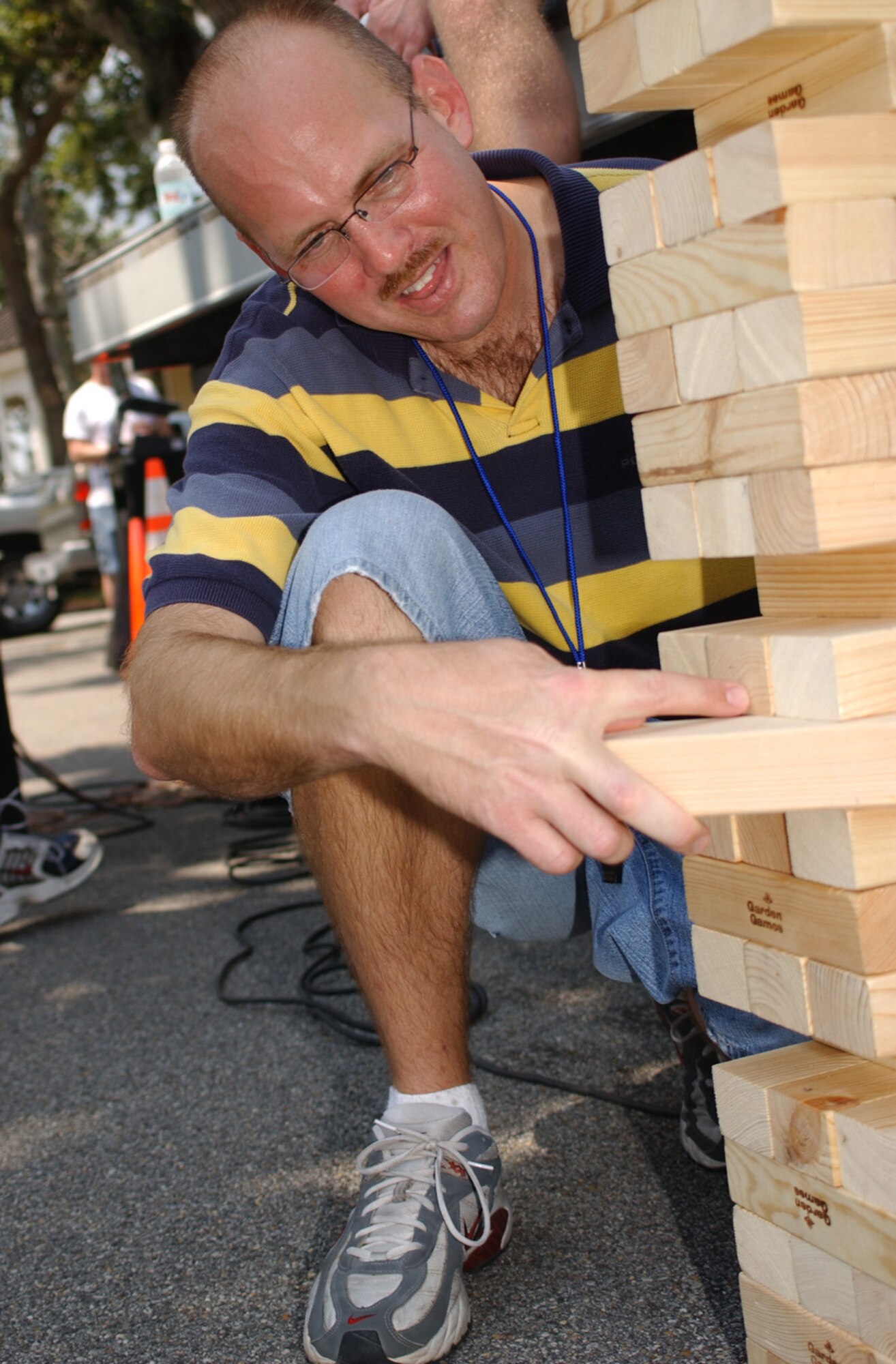 Master Sgt. Andrew Weldon, 332nd TRS, slides out a block while playing Jenga.  Other games were offered at the picnic, and several drawings were held for door prizes.  (U.S. Air Force photo by Kemberly Groue)