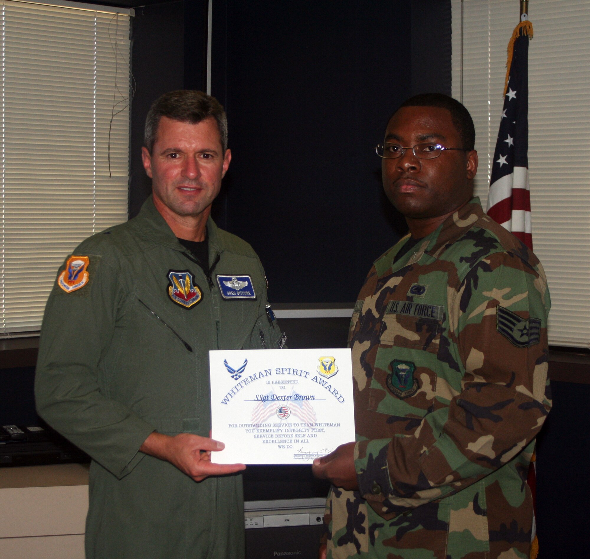 WHITEMAN AIR FORCE BASE, Mo., -- Left to right: Brig. Gen. Greg Biscone, 509th Bomb Wing commander, presents the Whiteman Spirit Award to Staff Sgt. Dexter Brown, 509th Logistics Readiness Squadron, Aug. 27. (U.S. Air Force photo/Maj. Joe DellaVedova)