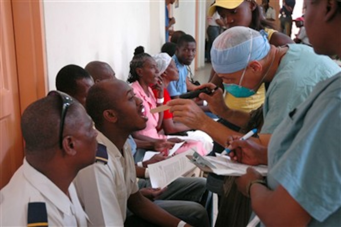 U.S. Public Health Service Capt. Angel Rodriguez-Espada, attached to hospital ship USNS Comfort, screens patients at Centre Hospitalier Eliazar Germain in Pétion-Ville, Port-au-Prince, Haiti, Sept. 3, 2007. Comfort is on a four-month humanitarian deployment.