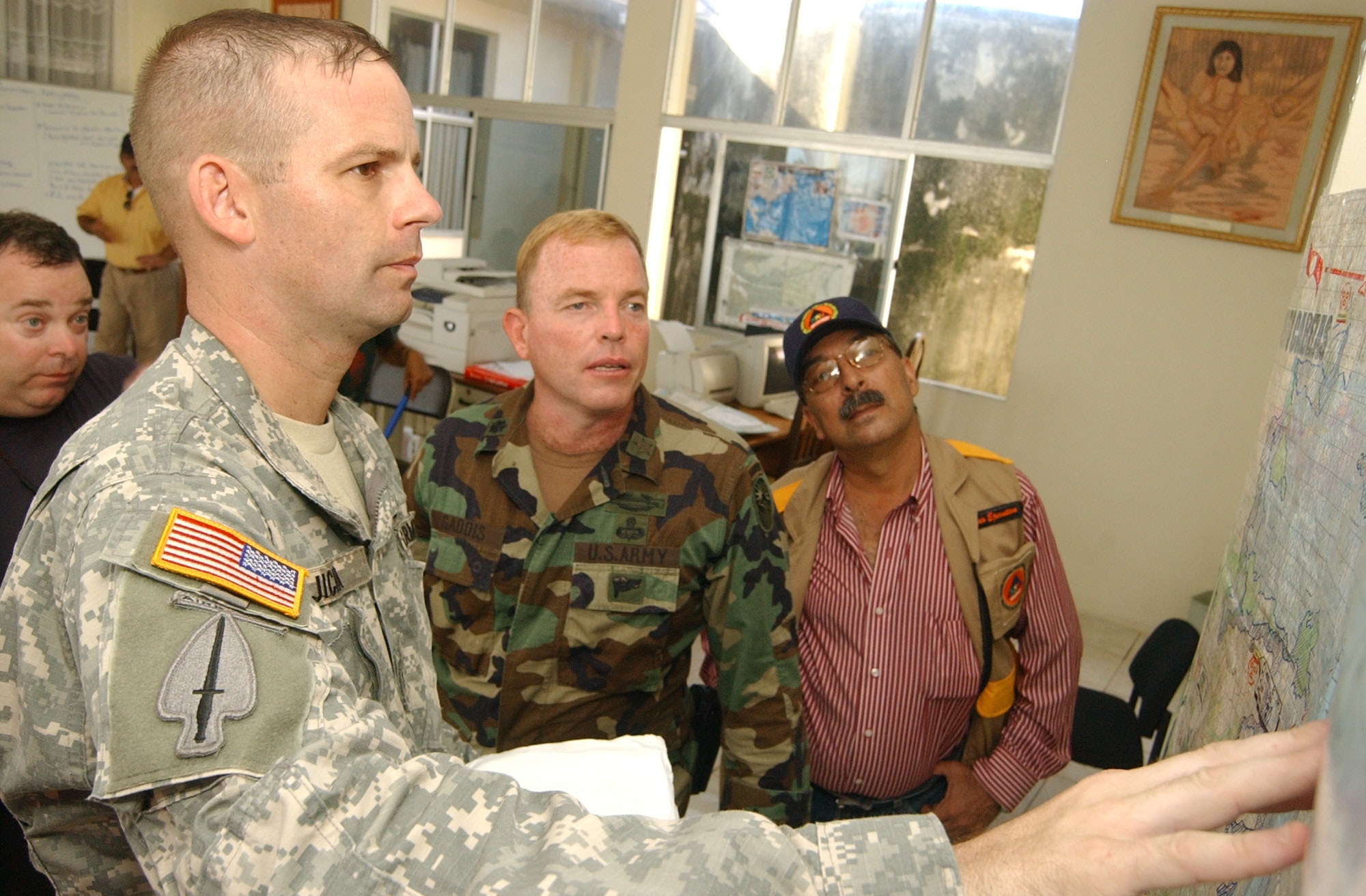 PUERTO CABEZAS, Nicaragua ? Army Lt. Col. Gregory Jicha, commander of a 13-person task force here from Soto Cano Air Base, Honduras, reviews a map with Army Lt. Col. Robert Gaddis, U.S. Military Group Nicaragua, and Ramon Arnesto, director of the Nicaraguan federal emergency management agency, SINAPRED, prior to a hurricane assessment flight over the areas of the country affected by Hurricane Felix.  U.S. Air Force photo by Tech. Sgt. Sonny Cohrs                               