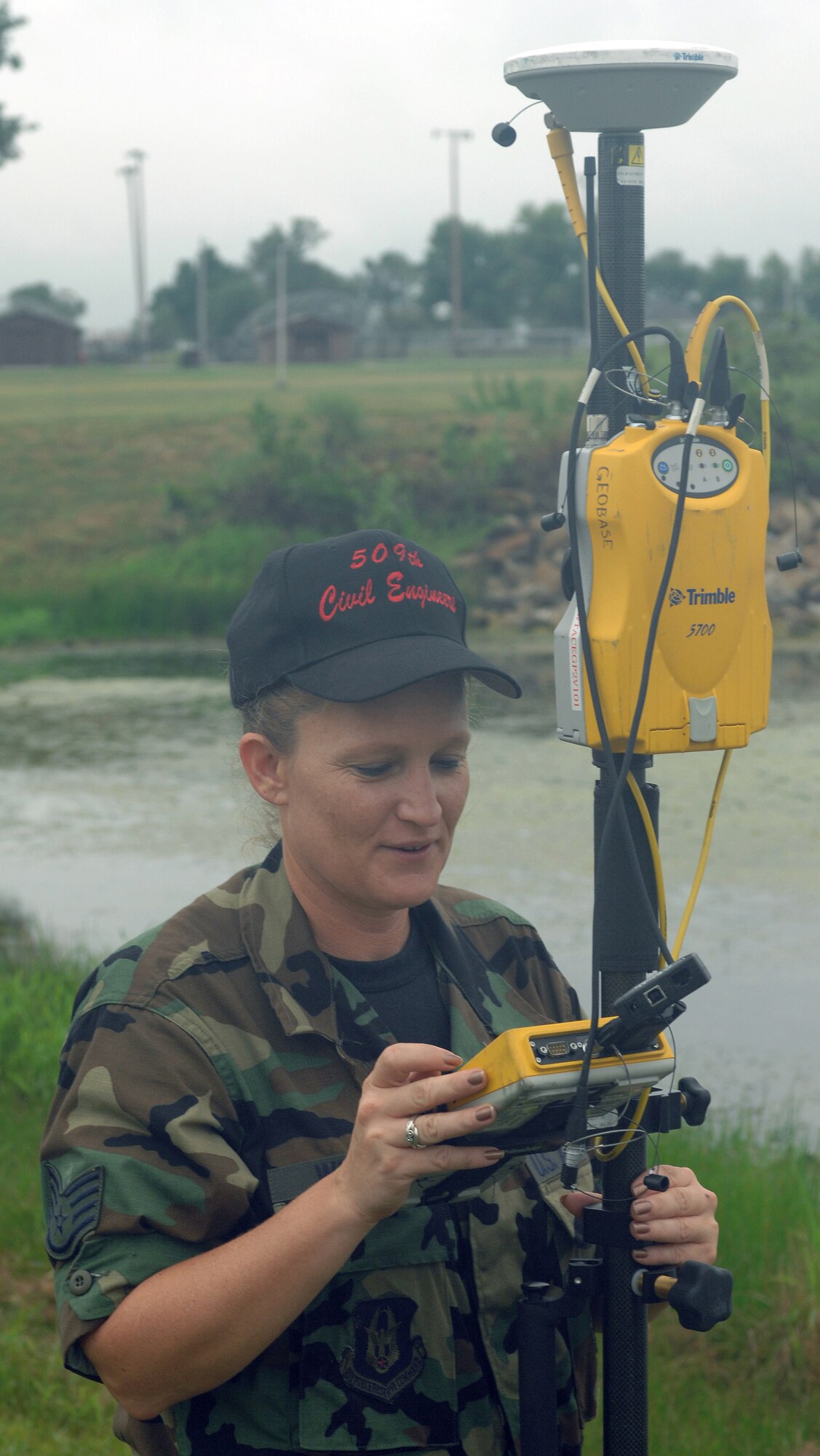 WHITEMAN AIR FORCE BASE, Mo. --  Staff Sgt. Clara Winkler, 509th Civil Engineer Squadron, measures elevation around the base lake with GPS surveying equipment Sept. 6. Winkler is a Reservist from the 442nd Fighter Wing currently on active duty with the 509th CES. (U.S. Air Force Photo/Tech. Sgt. Samuel A. Park)
