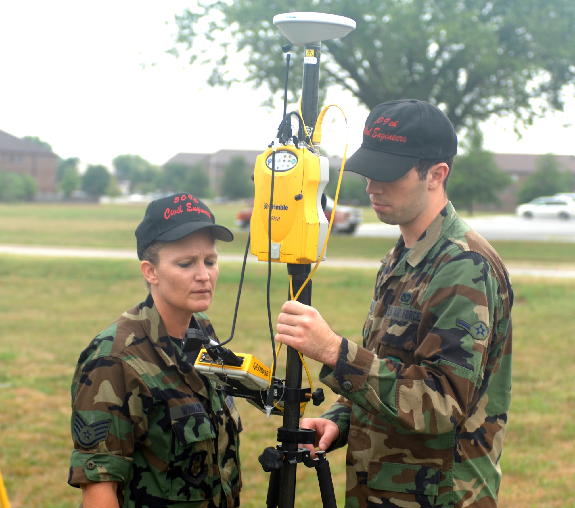 WHITEMAN AIR FORCE BASE, Mo. --  Staff Sgt. Clara Winkler and Airman Geoffrey Russel, 509th Bomb Wing Civil Engineer Squadron, set up a Trimble 5700 to survey numerous points around Skelton Lake Sept. 6. The information will be used to determine if a lake improvement project is possible. Winkler is a Reservist from the 442nd Fighter Wing currently on active duty with the 509th CES. (U.S. Air Force Photo/Tech. Sgt. Samuel A. Park)