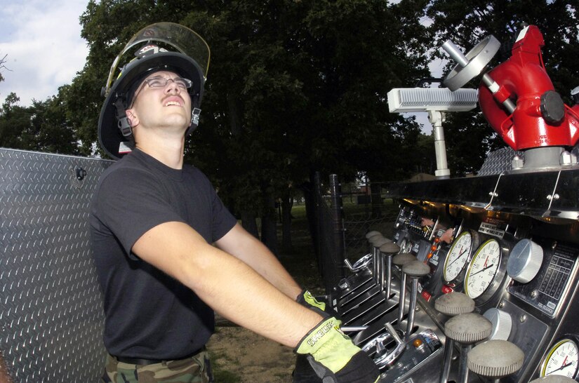 Airman Brandon Schmidt performs driver operator training for the pumper hydraulics, which control water pressure to the fire hose.