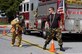 Senior Airman Travis Gilmour, right, encourages Airman Maruc Scanlon while pulling a fire hose.