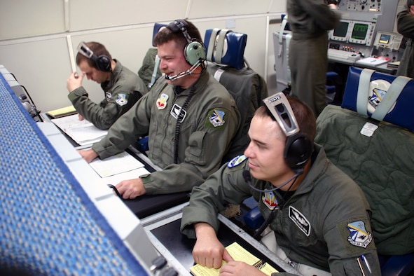 (From right to left) Senior Airman Chris States, Tech. Sgt. Gary Geiger and Senior Airman Dayton Pierce, 960th Airborne Air Control Squadron, man their surveillance stations. Air and senior surveillance technicians such as these Airmen are responsible for detecting, identifying and tracking all aircraft, foreign and domestic. (Photo by Staff Sgt. Stacy Fowler)