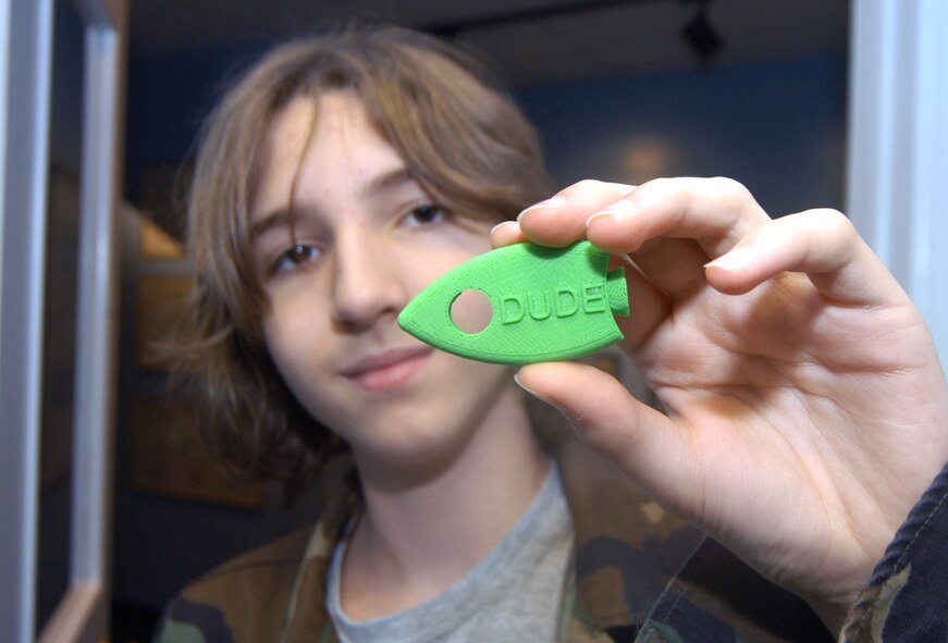 Thomas Ray shows off one of the tops for the flashlights that was created using the 3-D printer. U. S. Air Force photo by Sue Sapp 