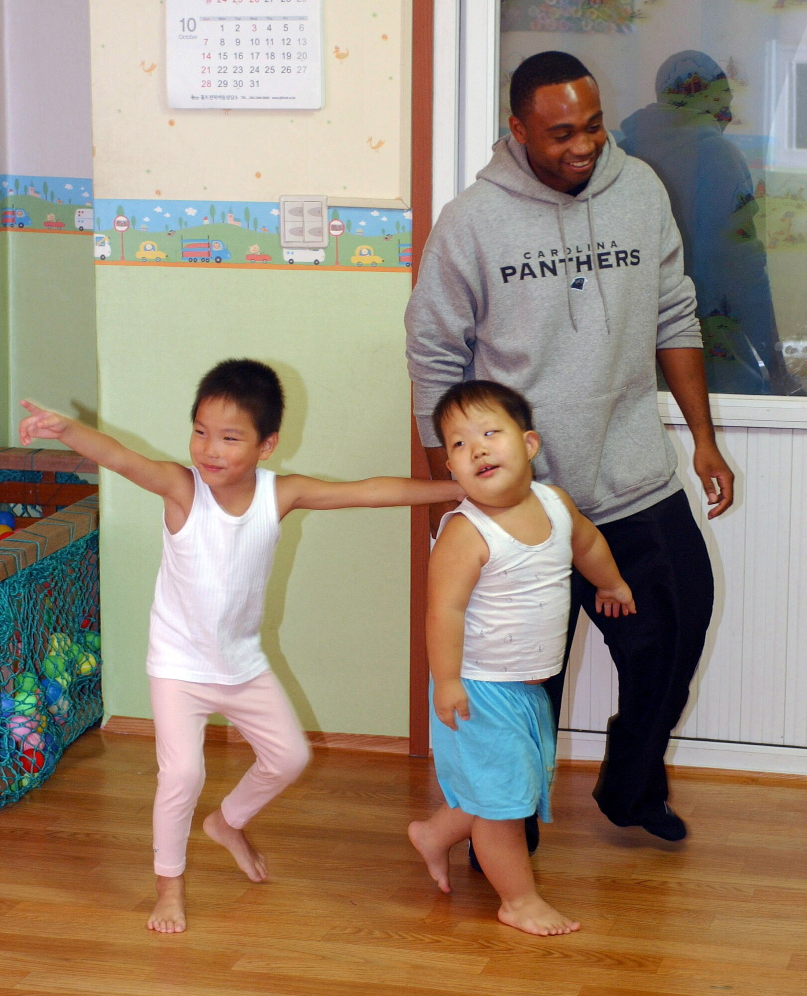 Senior Airman Gary Mallard plays with children at the Gunsan Orphanage Sept. 5 at Gunsan City, South Korea. Members of the 8th Logistics Readiness Squadron volunteered at the Kunsan Air Base Commissary in South Korea to raise money for the children at the Gunsan Orphanage as part of a Good Neighbor Program initiative. After presenting the money, they spent time with the children. Airman Mallard is assigned to the 8th Logistics Readiness Squadron. (U.S. Air Force photo/Senior Airman Steven R. Doty) 
