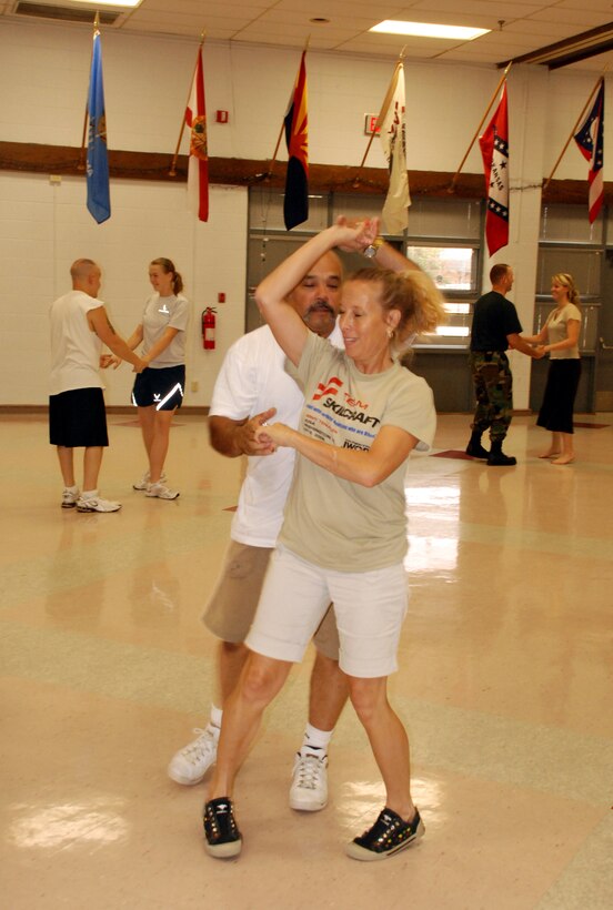 Randal and Lisa SanMiguel practice the 'pretzel' at the swing dance classes being held at the Community Activity Center.  The classes are to help the dancers prepare for their number at the Air Force 60th Anniversary Ball. (U.S. Air Force photo/Airman 1st Class Jacob Corbin)