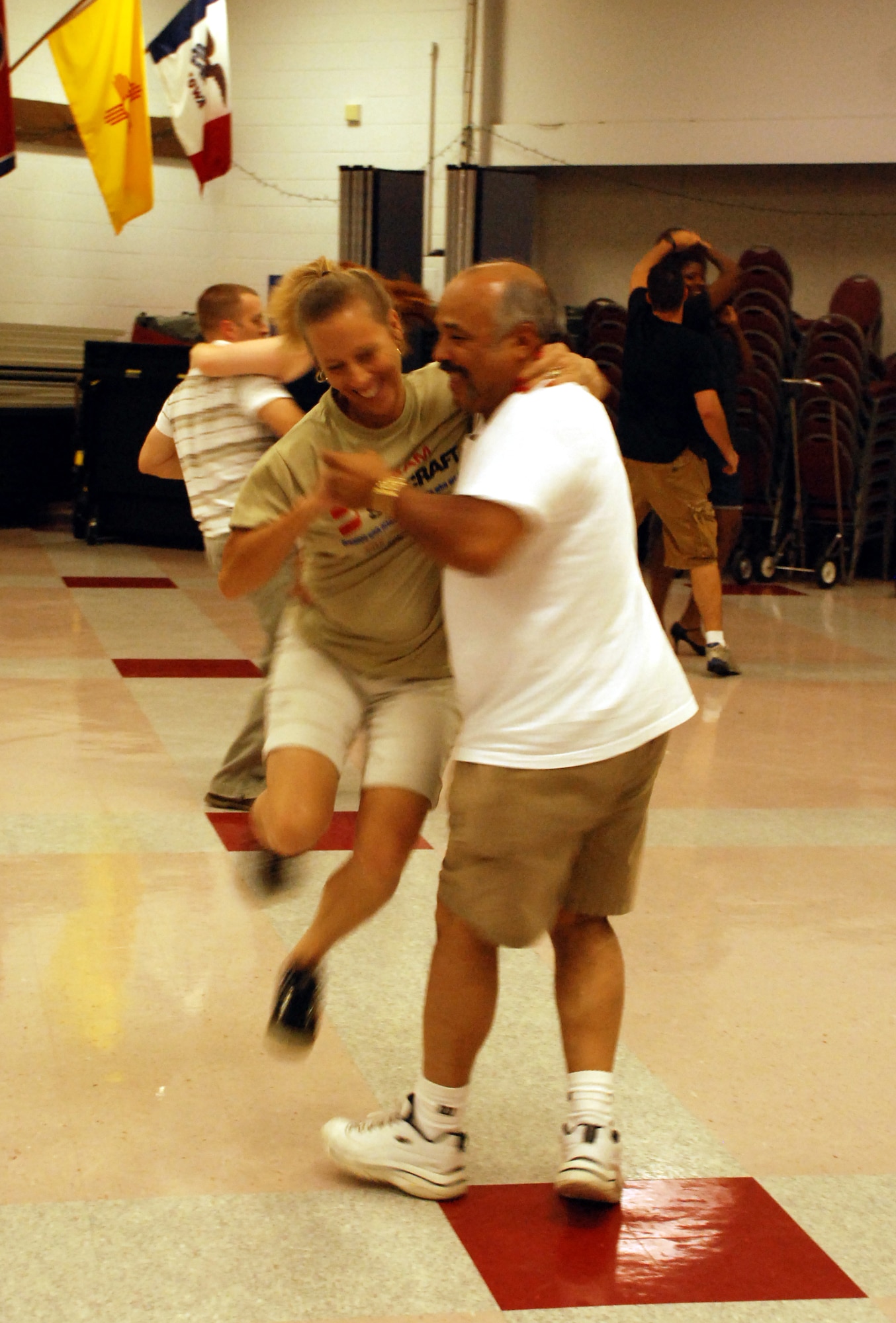 Randal SanMiguel, 383rd Training Squadron, and his wife Lisa practice the "around the world" move at the swing dance classes being held at the Community Activity Center. The classes are to help the dancers prepare for their number at the Air Force 60th Anniversary Ball. (U.S. Air Force photo/Airman 1st Class Jacob Corbin)