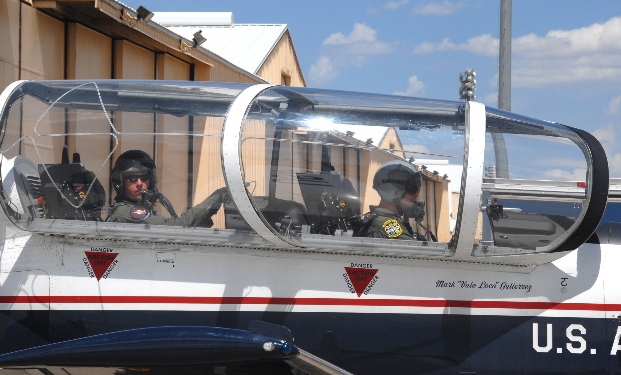 CANNON AIR FORCE BASE, N.M. -- Maj. Rick Wageman, left, an F-16 pilot and fighter enhancement program manager in the 27th Fighter Wing, Cannon Air Force Base, N.M., prepares for an orientation flight in a T-6A Texan II primary trainer at Cannon with Maj. Paul Dupuis of the 12th Flying Training Wing from Randolph AFB, Texas.  Two Texan IIs and their pilots visited Cannon AFB on Aug. 23-24 to demonstrate the capabilities of the T-6 and drum up interest among 27th FW F-16 pilots to become instructor pilots.  (Air Force photo by Chief Master Sgt. Gary Emery) 