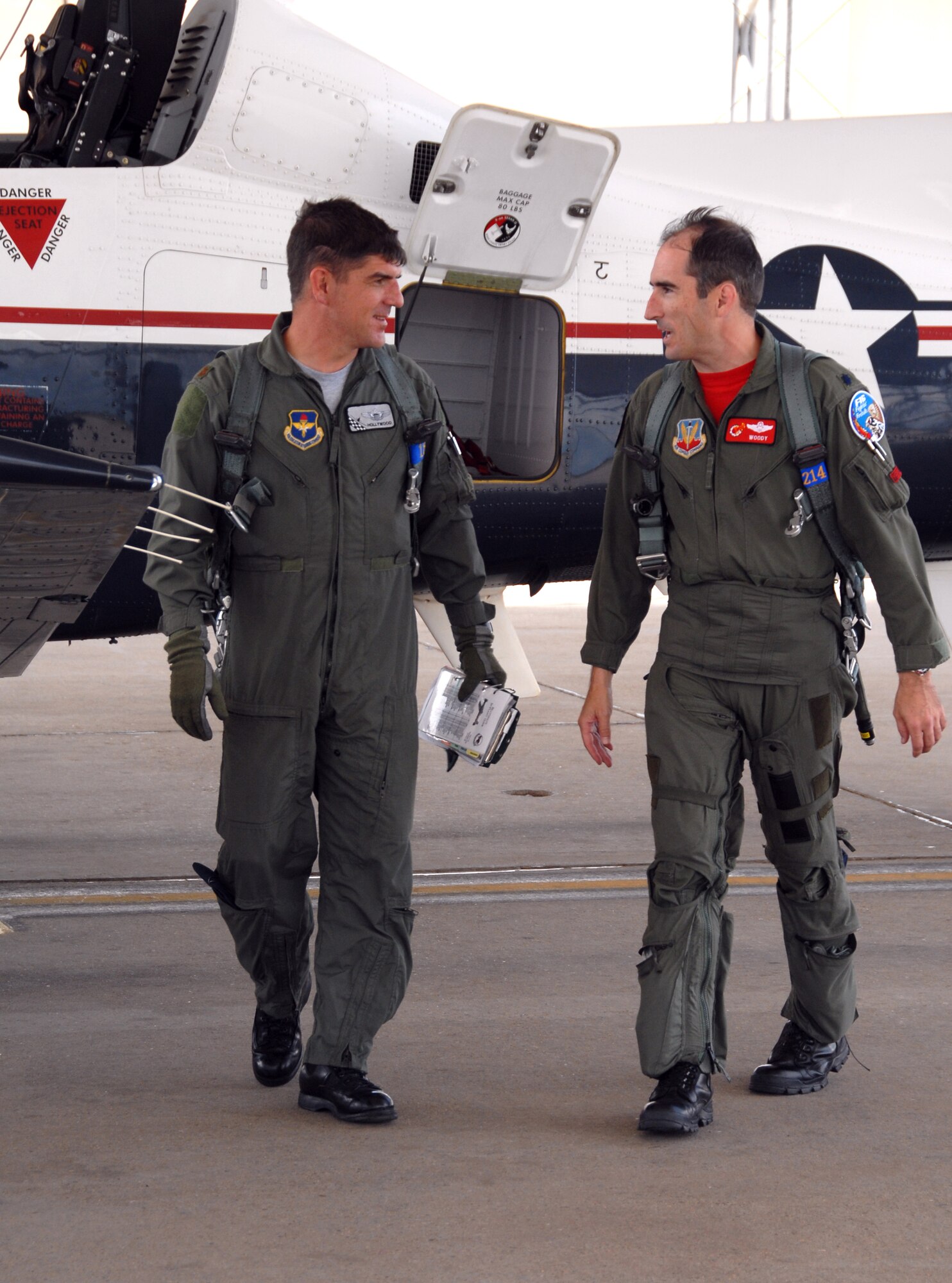 CANNON AIR FORCE BASE, N.M. -- Maj. Tommy Hudnall, left, an instructor pilot with the 12th Flying Training Wing, Randolph Air Force Base, Texas, and Lt. Col. Ancel Yarbrough, the 27th Fighter Wing Chief of Safety at Cannon Air Force Base, N.M., discuss their mission after an orientation flight in a T-6A Texan II primary trainer at Cannon on Aug. 24.  Two Texan IIs and their pilots visited Cannon AFB on Aug. 23-24 to demonstrate the capabilities of the T-6 and drum up interest among 27th FW F-16 pilots to become instructor pilots.  (Air Force photo by Chief Master Sgt. Gary Emery)