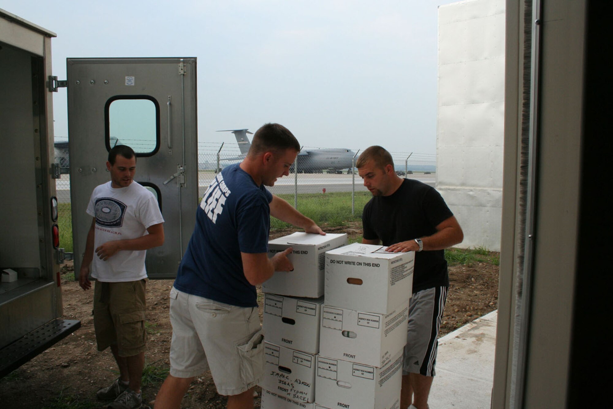 WRIGHT-PATTERSON AFB, Ohio - Reservists from the 89th Airlift Squadron, left to right, Bryant Fox, Matt Pfeifer, and Blake LeMaster unload boxes into the new C-5 Squadron Operations Facility Sept. 6, 2007. The new building will support squadron operations; this includes aircrew, life support, intelligence, training, and office space.  (U.S. Air Force photo/Mary Allen)      