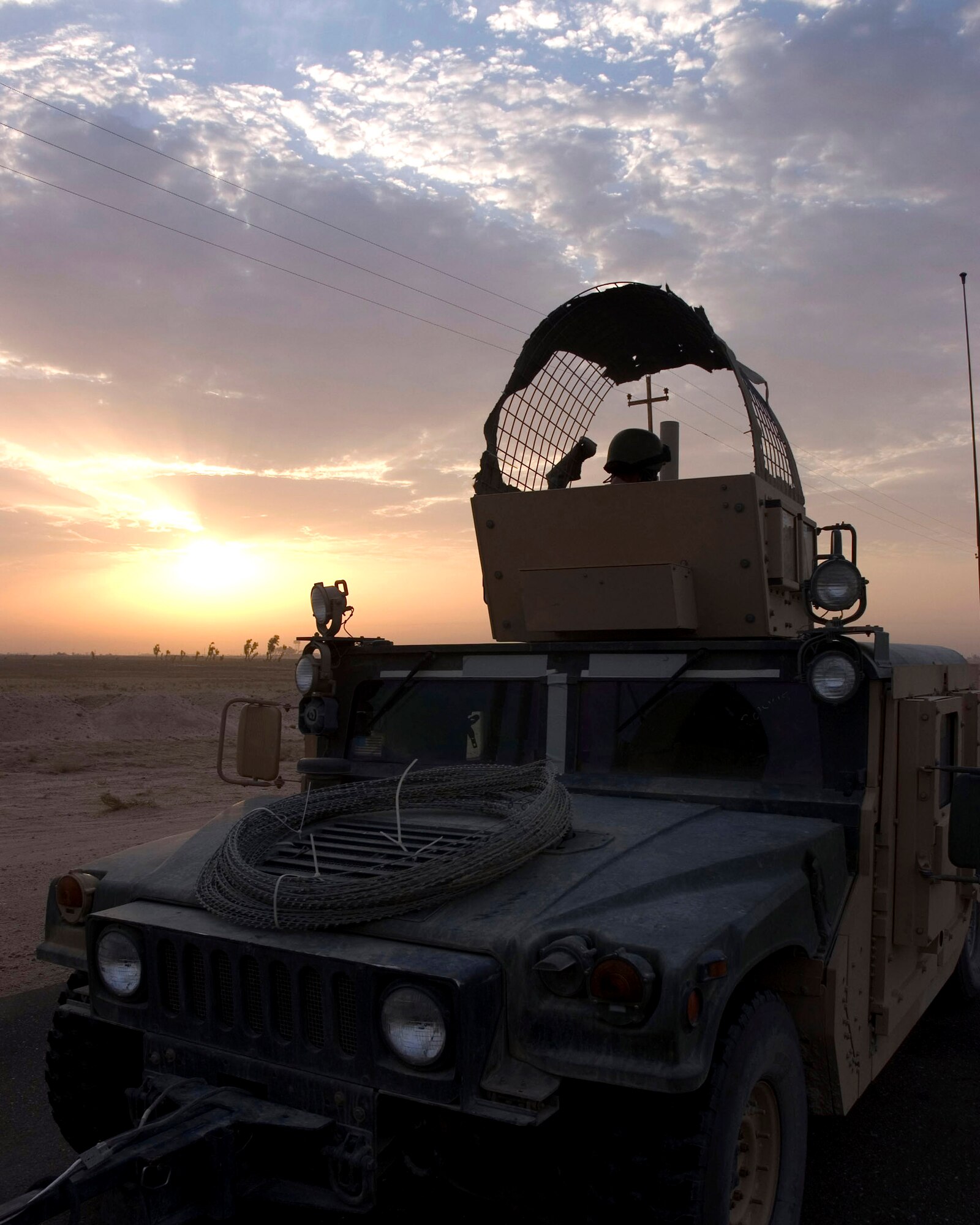 An 887th Expeditionary Security Forces Squadron Humvee slowly rolls forward while on patrol in August in southern Iraq. Members of the 887th ESFS patrol convoy routes to keep them clear of improvised explosive devices. (U.S. Air Force photo/Staff Sgt. Raymond Mills) 
