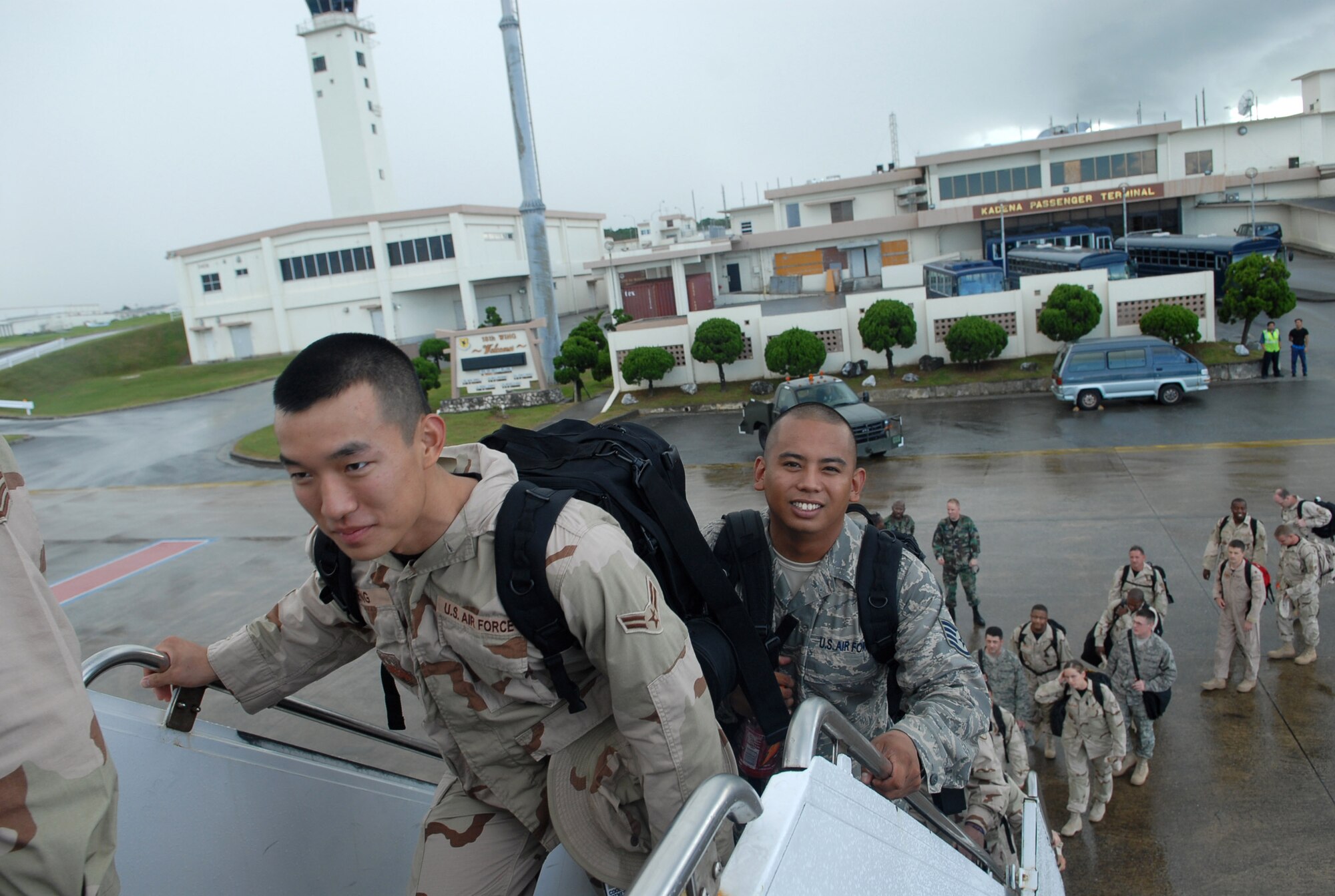 Airman 1st Class David Zheng and Staff Sgt. Joshua Garcia board a contract aircraft Sept. 2 at Kadena Air Base, Japan. More than 240 Airmen from seven Pacific Air Forces bases left Kadena AB for Southwest Asia to support operations Iraqi Freedom and Enduring Freedom.  Both Airmen are assigned to 18th Wing Public Affairs.  (U.S. Air Force photo/Maj. Dani Johnson)