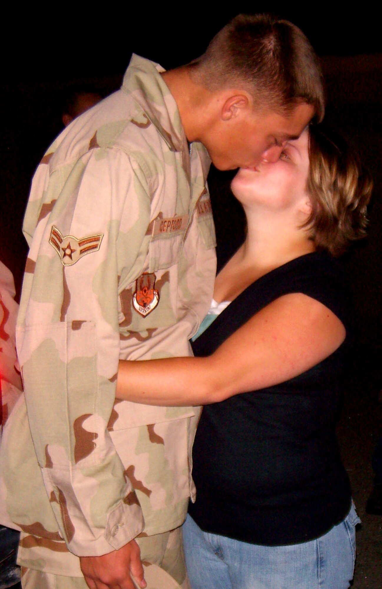 Airman 1st Class benjamin Gepford, 49th Civil Engineer Squadron, kisses his wife goodbye before hopping on an airplane to Southwest Asia. More than 35 Holloman Airmen leave early Sept. 6 for a deployment in support of the War on Terror. These Airmen are a part of approximately 700 Airmen deploying in the upcoming Air and Space Expeditionary cycle. (U.S. Air Force photo/Airman 1st Class Heather Stanton)