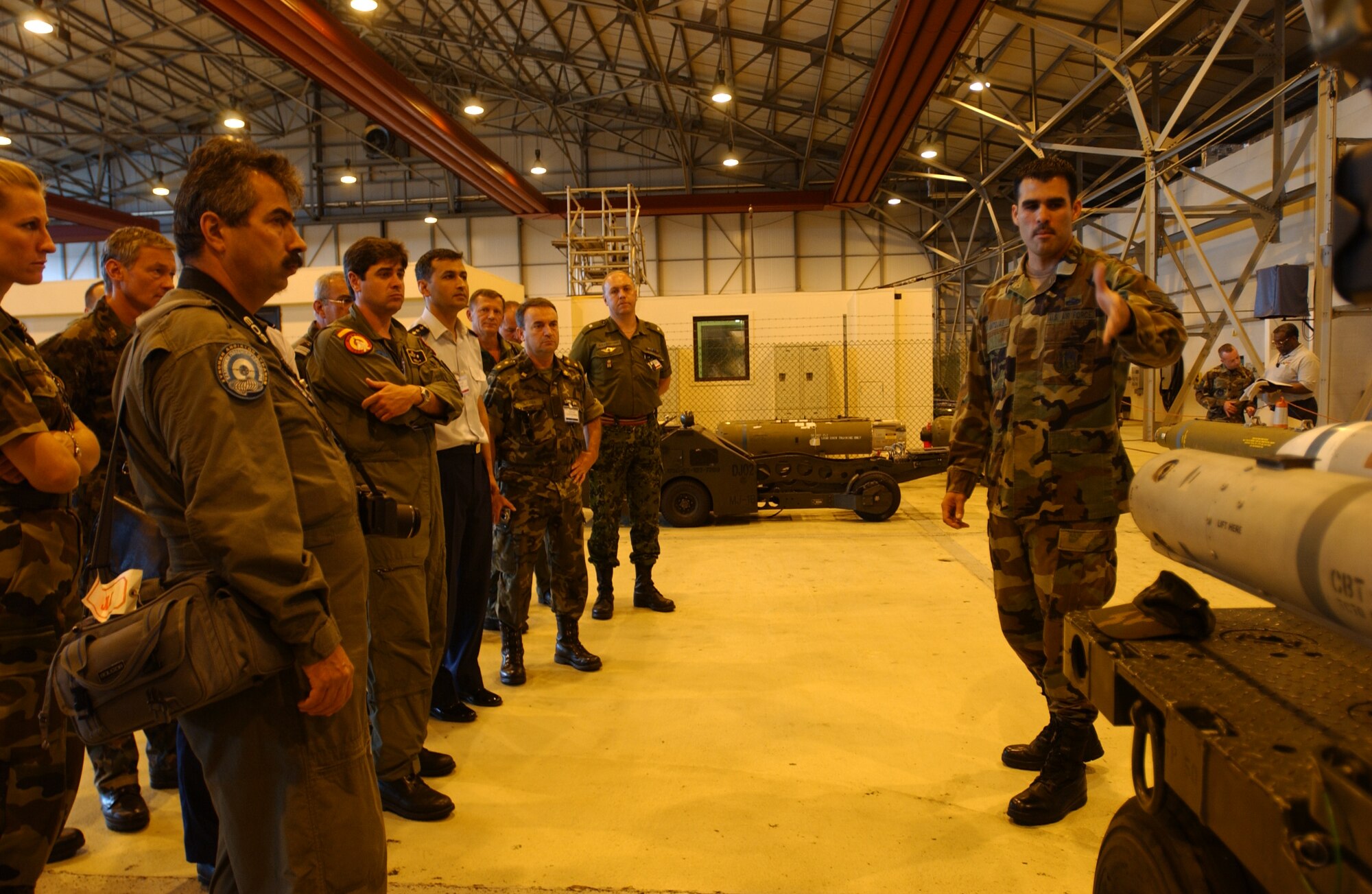 An Airmen with the 48th Munitions Squadron explains the mechanics of a munitions to foreign officers during the annual Conventional Forces in Europe Treaty Inspection. RAF Lakenheath will be involved in the CFE inspection Sept. 20. (U.S. Air Force photo)