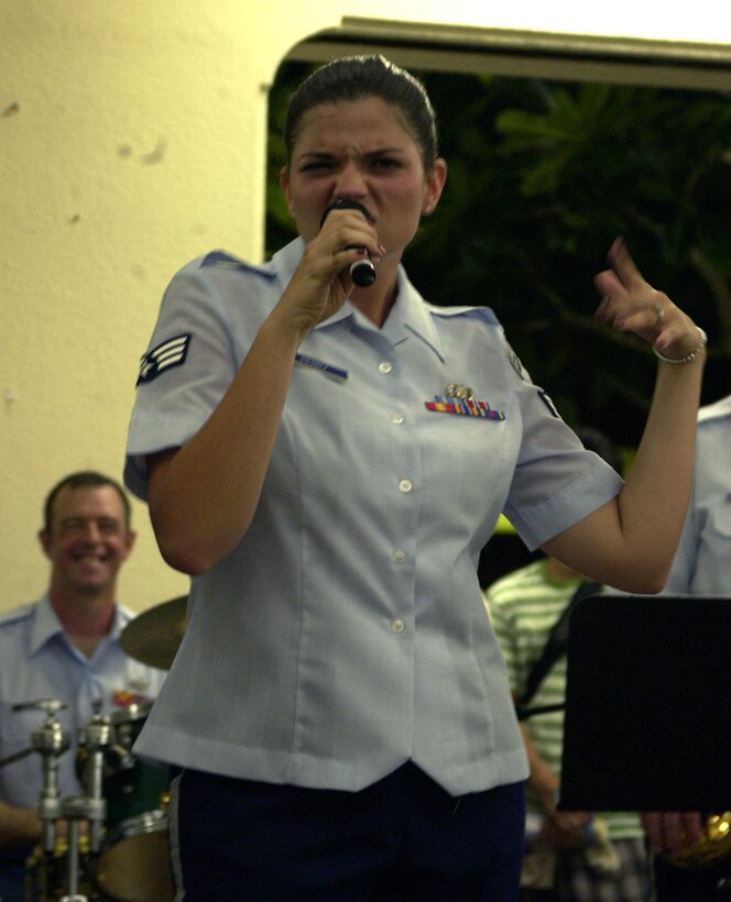 HAGATNA, Guam - Senior Airman Kelly Perry, a vocalist with the U.S. Air Force Band of the Pacific, performs with the Alaskan Express at Chamorro Village in Hagatna, Guam. The band visited the island in conjunction with Guam's Air Force Week.  Chamorro Village was one of many locations the band performed at from Sept. 4 to 8.  (Photo by Tech. Sgt. Brian Bahret/ 36th Wing Public Affairs)   